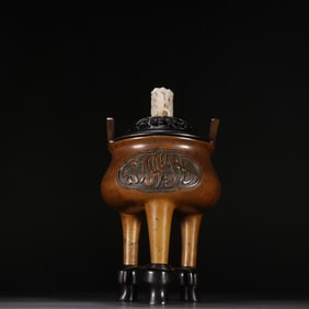 A copper incense burner with upturned ears and three feet, Ming Dynasty