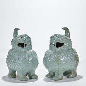 A pair of auspicious animal incense burners with official glaze