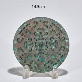 A copper mirror with inlaid silver and gold and turquoise from before the Ming Dynasty
