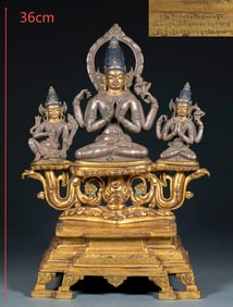 A Ming Dynasty four-armed Guanyin Buddha statue with silver body and gold inlay