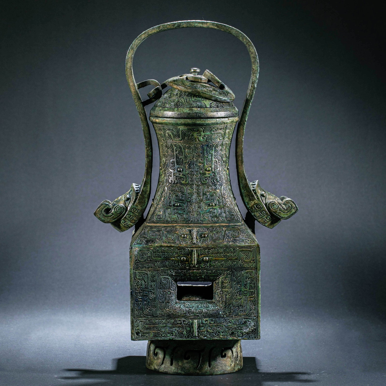 Pre-Ming Dynasty Bronze You (Ritual Wine Vessel) with Loop Handle and Square Belly: Pre-Ming Dynasty Bronze You (Ritual Wine Vessel) with Loop Handle and Square BellyH.30cm W.11.2cm L.28.5cm Weight.2750grams