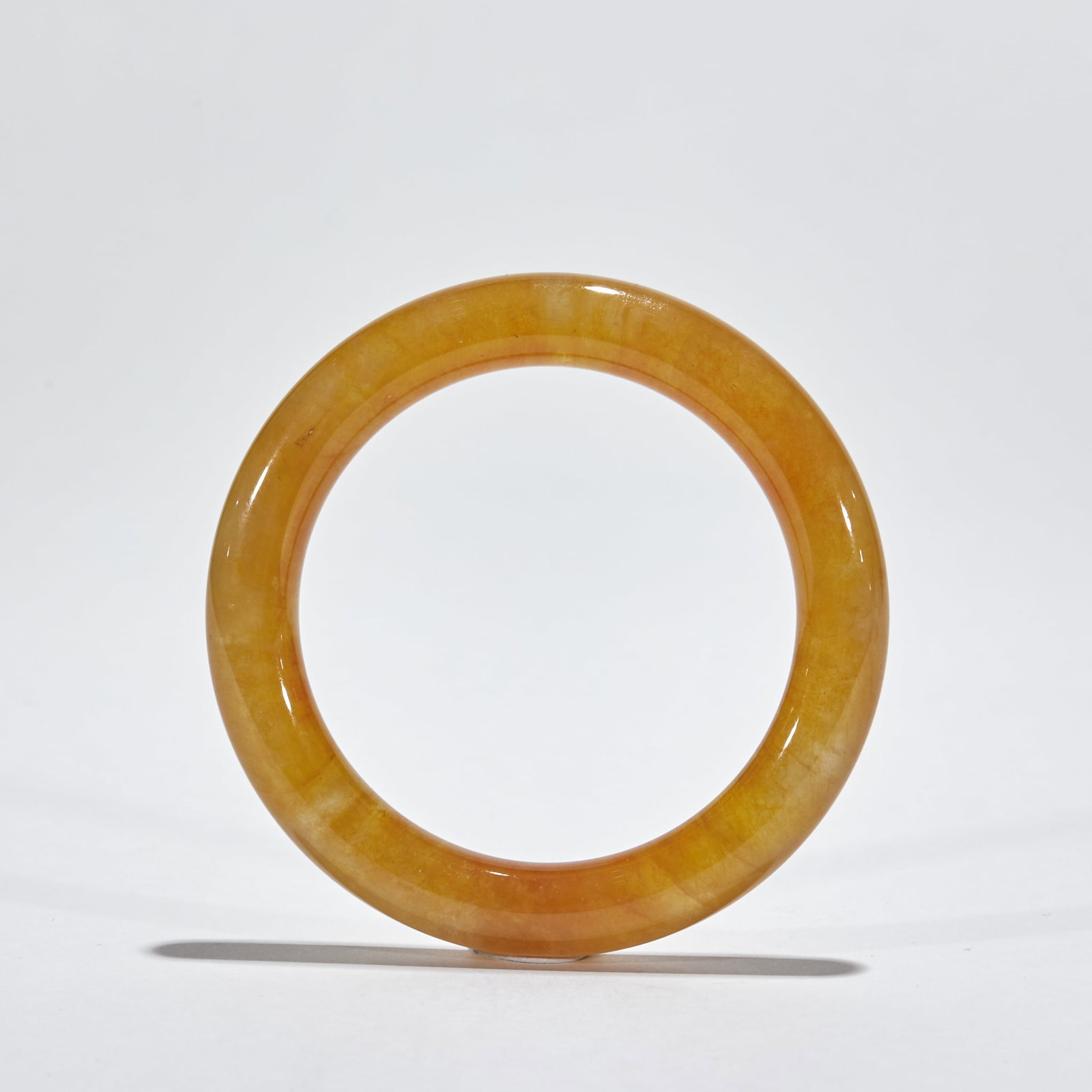 Yellow Jadeite Bangle: Yellow Jadeite Bangle Made of rare yellow jadeite, this bangle has an inner diameter of 6 cm and weighs 79 g; the uniform, warm yellow color and smooth texture embody the aesthetic of traditional
