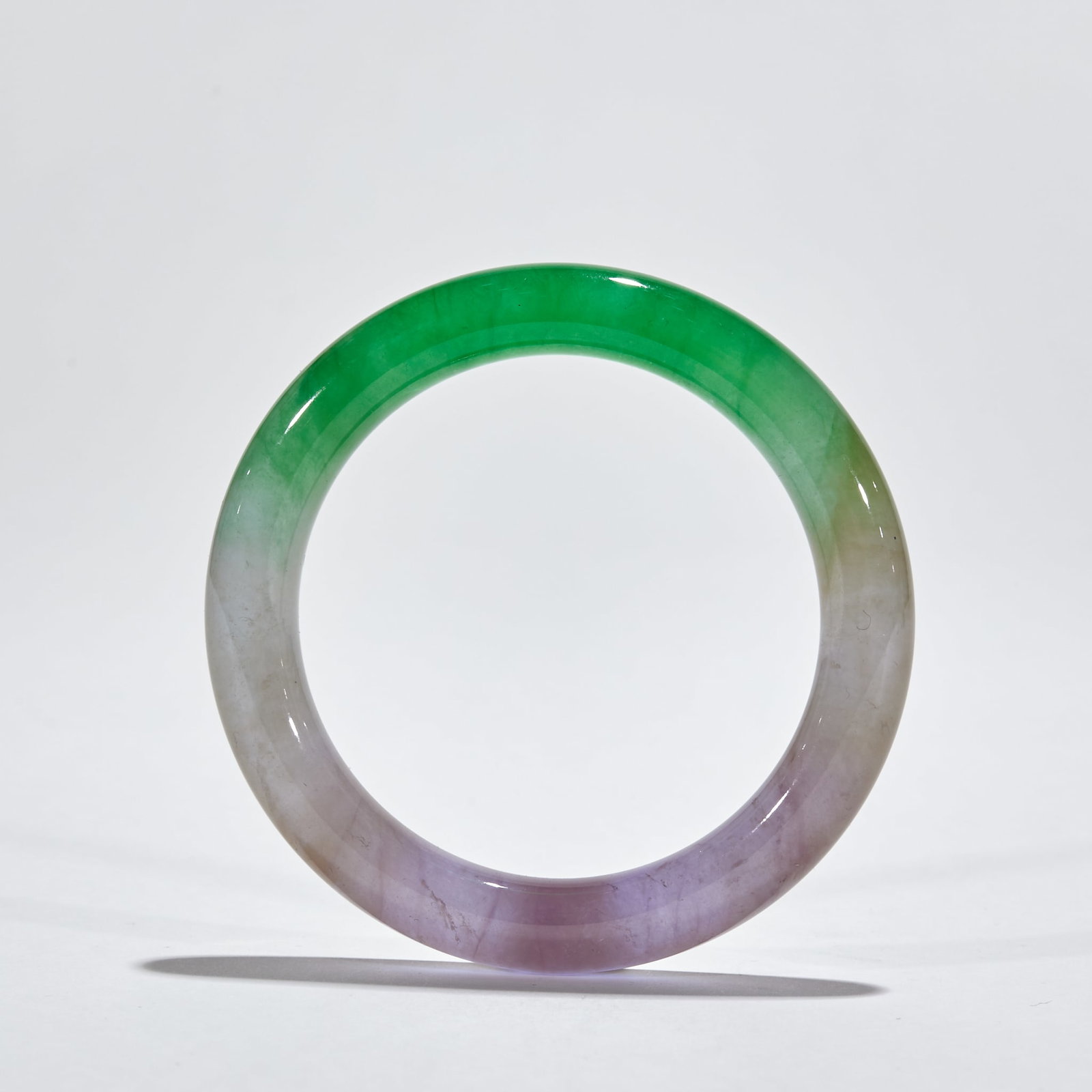Three-Color Jadeite Bangle: Three-Color Jadeite Bangle : Carved from natural jadeite with vibrant green, lavender, and yellow hues, this bangle features a smooth, translucent texture, measuring 6 cm in inner diameter and