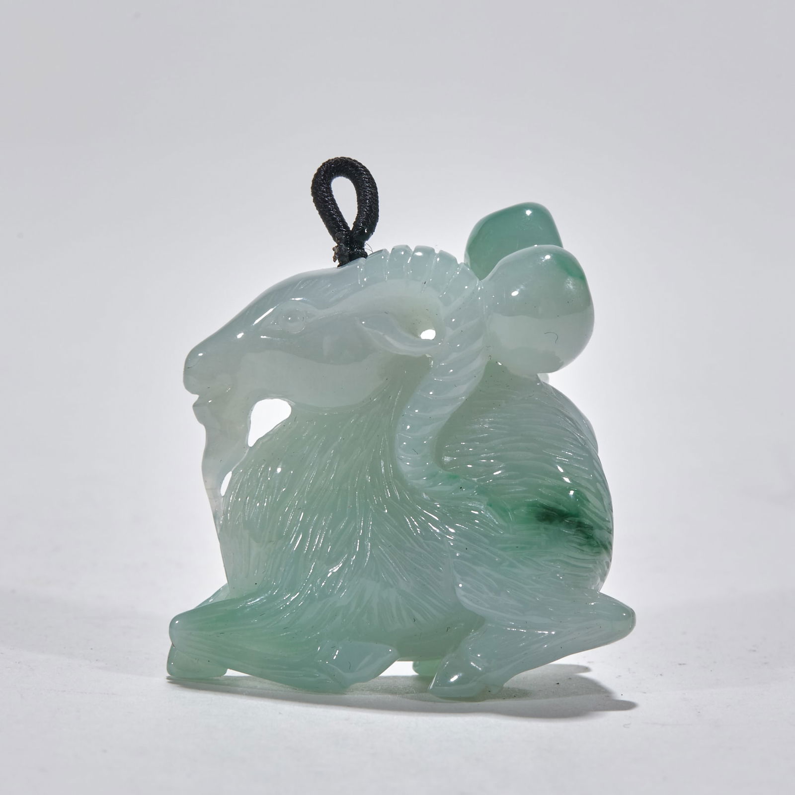Jadeite Ram Ornament: Jadeite Ram: Material is natural jadeite, carved into a ram shape via round carving technique, height 4cm, length 3.7cm, width 2cm, cultural value: "ram" is homophonic with "auspicious", meaning good