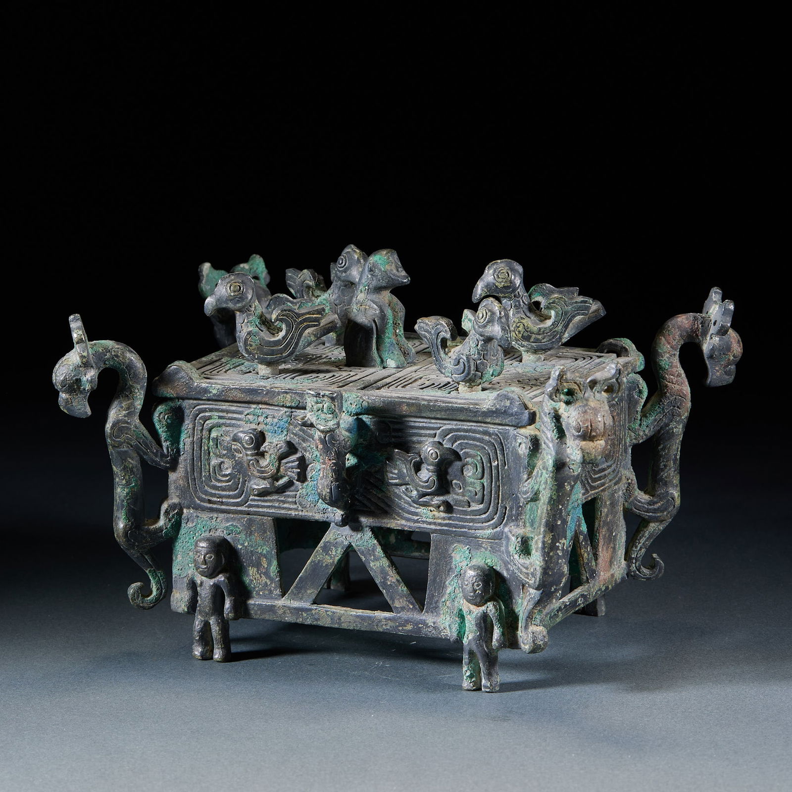 Pre-Ming Bronze Box: Four Men Carrying Four Dragons & Phoenixes: Pre-Ming Bronze Box with Four Men Carrying Four Dragons & Phoenixes: Made of bronze via mold casting, decorated with four dragons and four phoenixes patterns, supported by four men carrying shape at