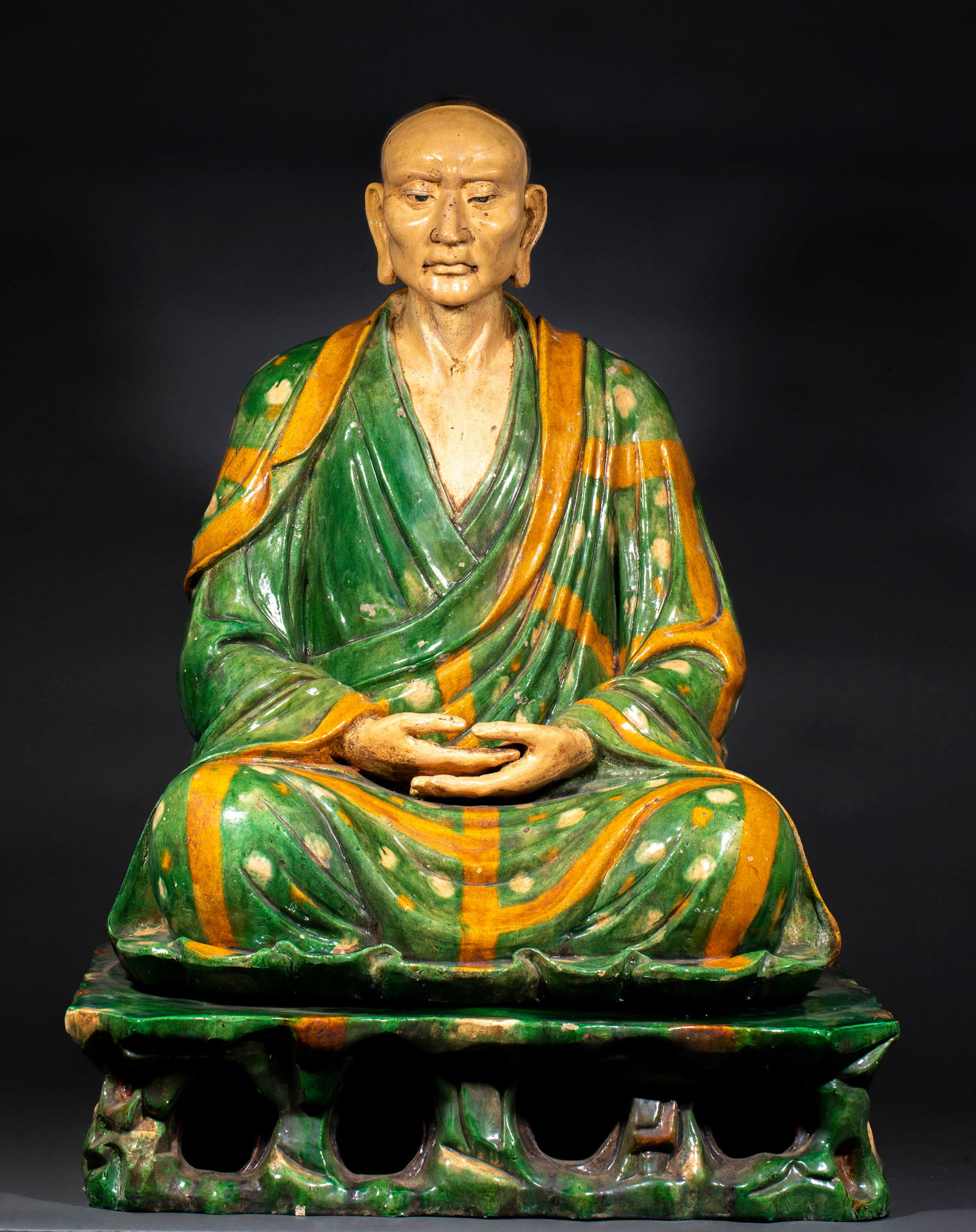 Liao Sancai Seated Arhat Statue: Liao Sancai Seated Arhat Statue: Material is sancai glazed pottery, made via molding, glazing and firing techniques, realistic arhat face and smooth clothing lines, hollow carved base, total height