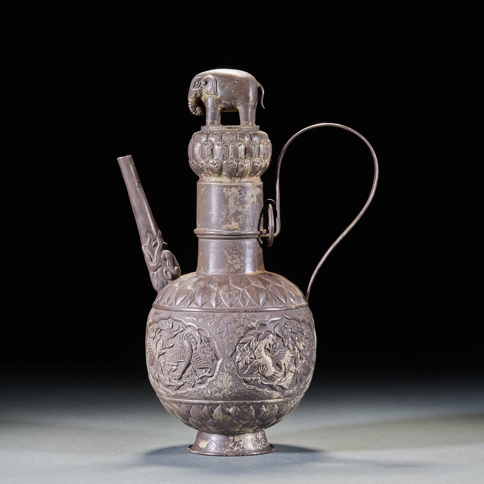 Pre-Ming Pure Silver Ewer with Flower & Phoenix Pattern: Pre-Ming Pure Silver Ewer with Flower & Phoenix Pattern: Made of pure silver via hammering and chiseling techniques, carved with flower & phoenix pattern, auspicious elephant knob on the top of the ew