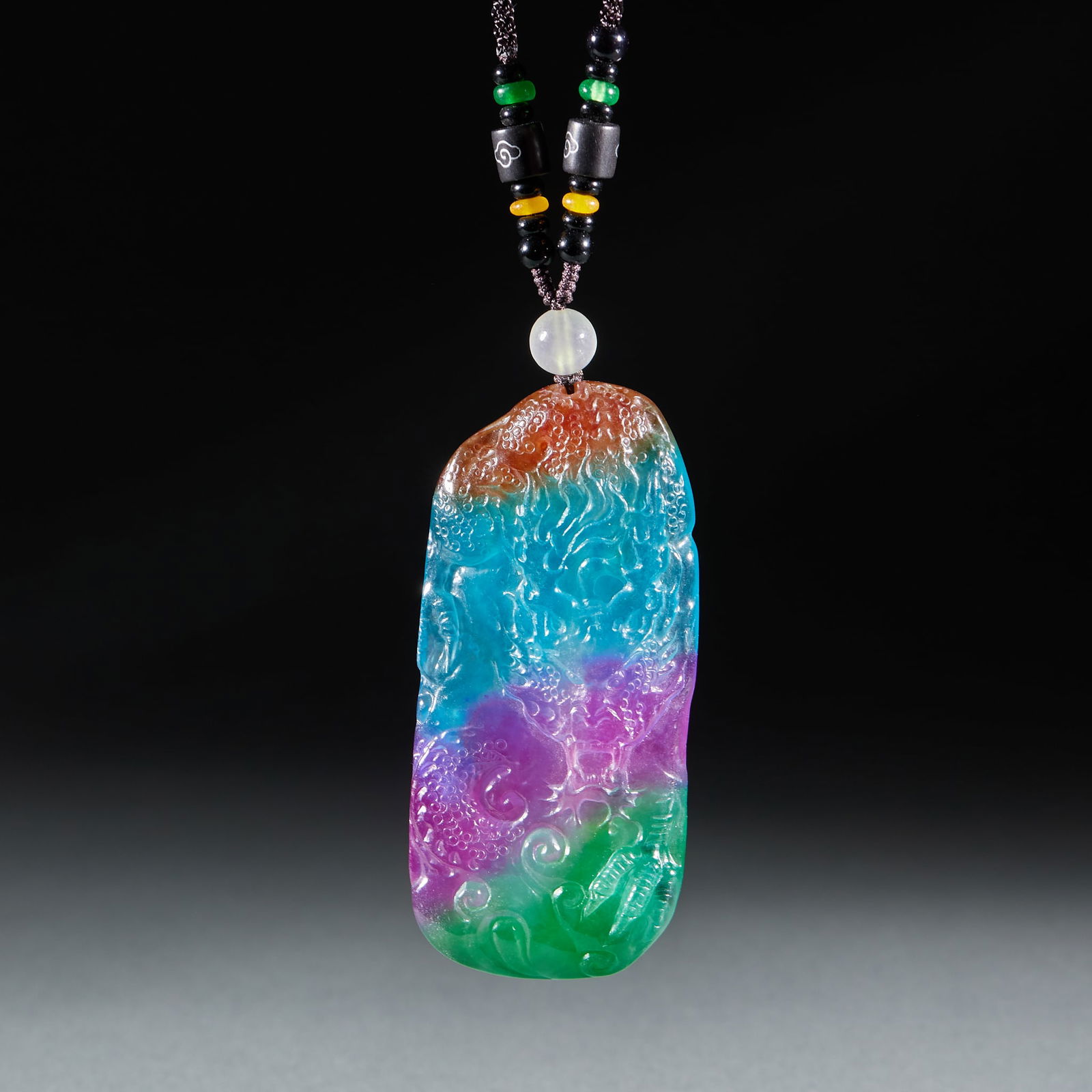 Jadeite Coiled Dragon Pendant: Jadeite Coiled Dragon Pendant: Material is multi-color jadeite, carved with coiled dragon pattern via relief and openwork techniques, rich color layers (red, blue, purple, green etc.), transparent tex