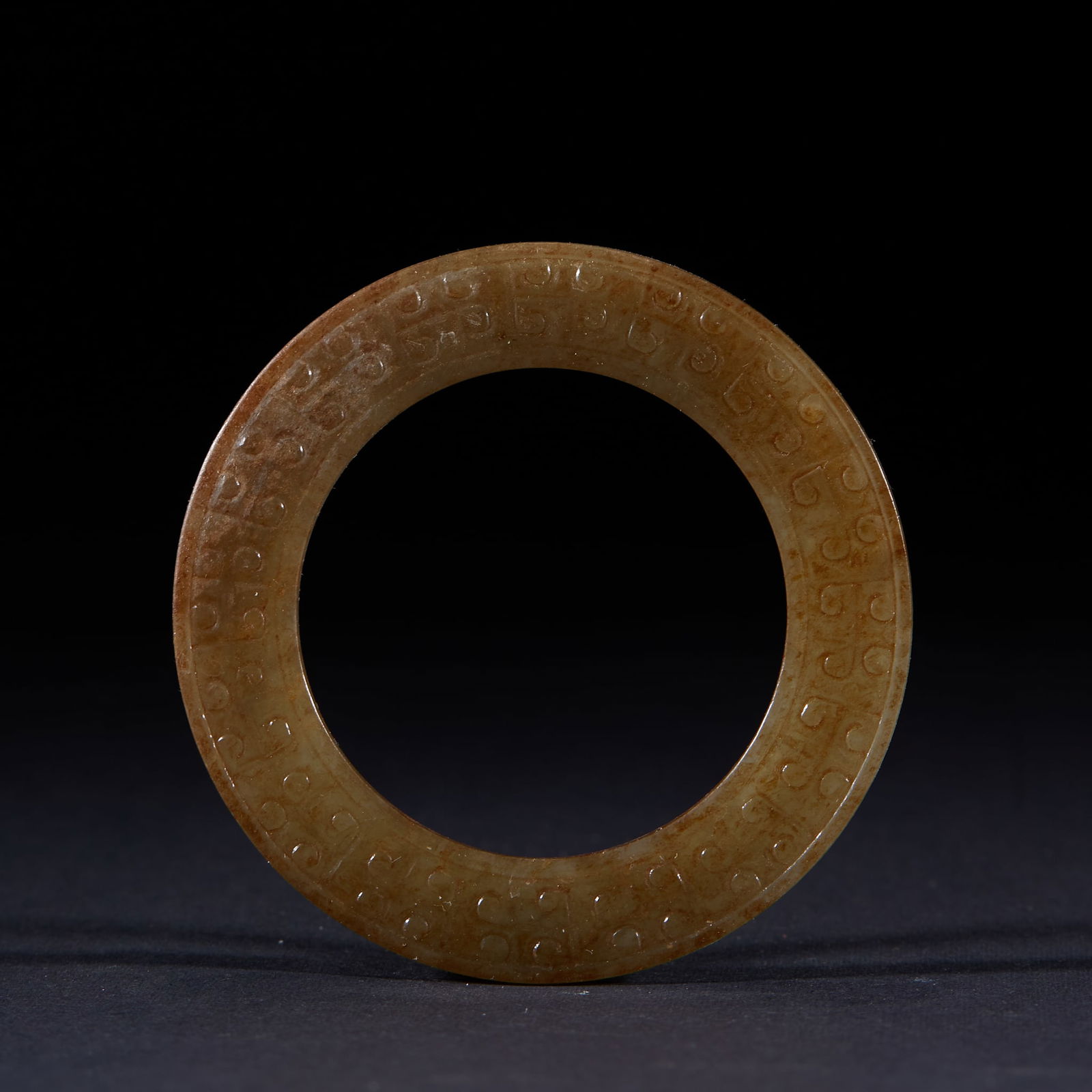 Ancient Jade Ring: Ancient Jade Ring: Made of ancient jade, carved with grain patterns or cloud patterns via intaglio technique, regular shape with natural calcification, thickness 0.4cm, diameter 6.5cm. As an ancient