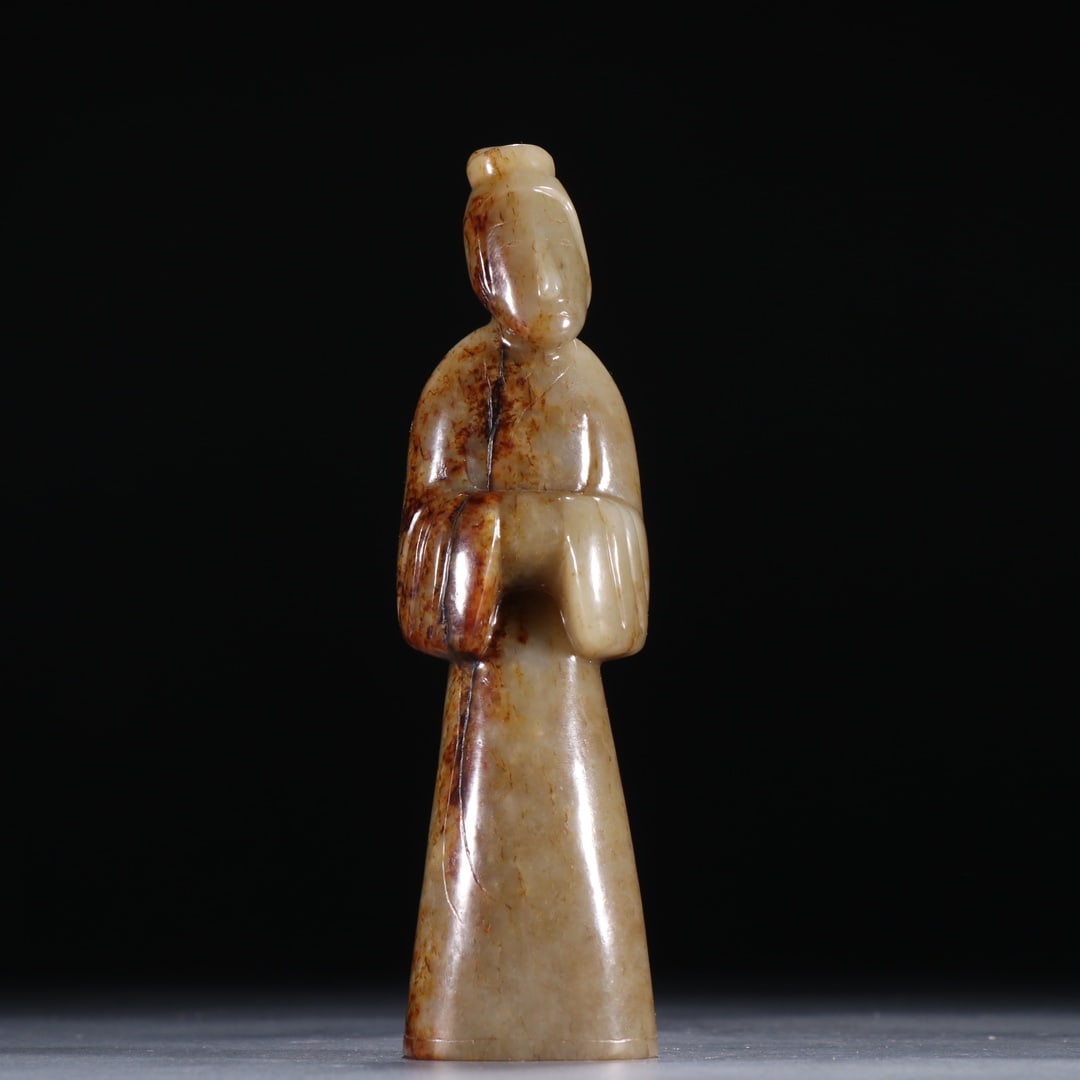 Hetian Jade Figurine Statue Ornament: Hetian Jade Human Figurine Ornament: Round carved Hetian jade sitting human figurine utilizing natural patina, simple ancient lines and natural patina; specifications: height 14cm, width 3.8cm,