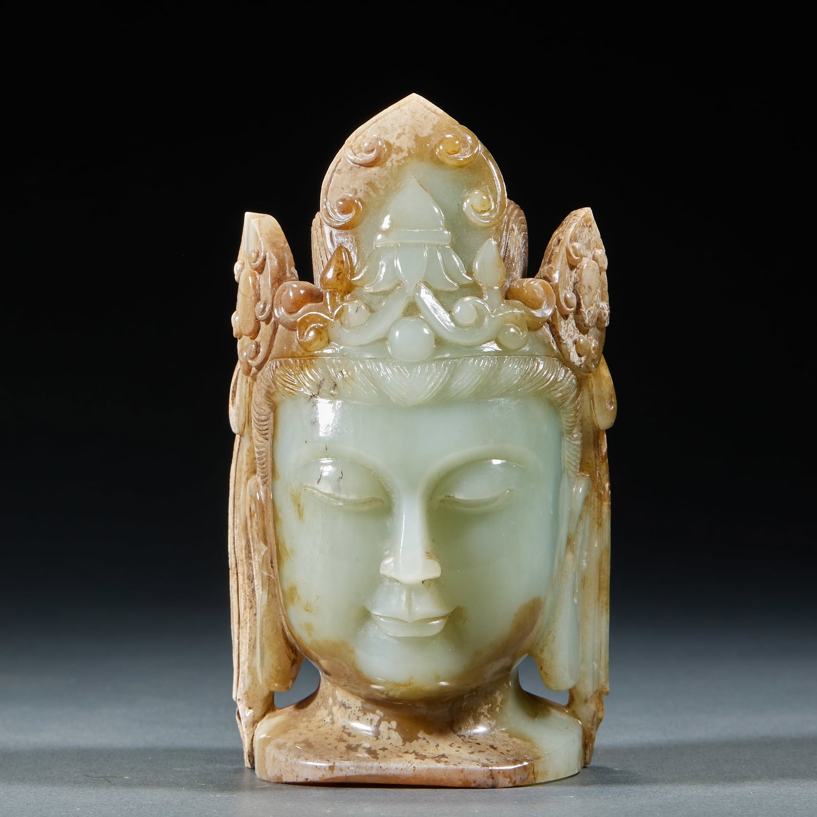 Hetian Jade Guanyin Head: Hetian Jade Guanyin Head: Material is Hetian greenish white jade with natural infiltration. Crafted with round carving of a Guanyin head, crown carved with scroll and lotus patterns, compassionate