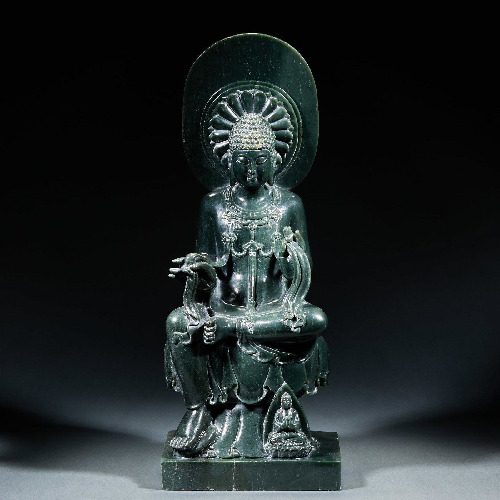 Hetian Jasper Sakyamuni Statue: Hetian Jasper Sakyamuni Statue: Material is Hetian jasper. Crafted with round and openwork carving of a seated Sakyamuni with crown and rosaries, small Buddhas carved on the base, steady green color.