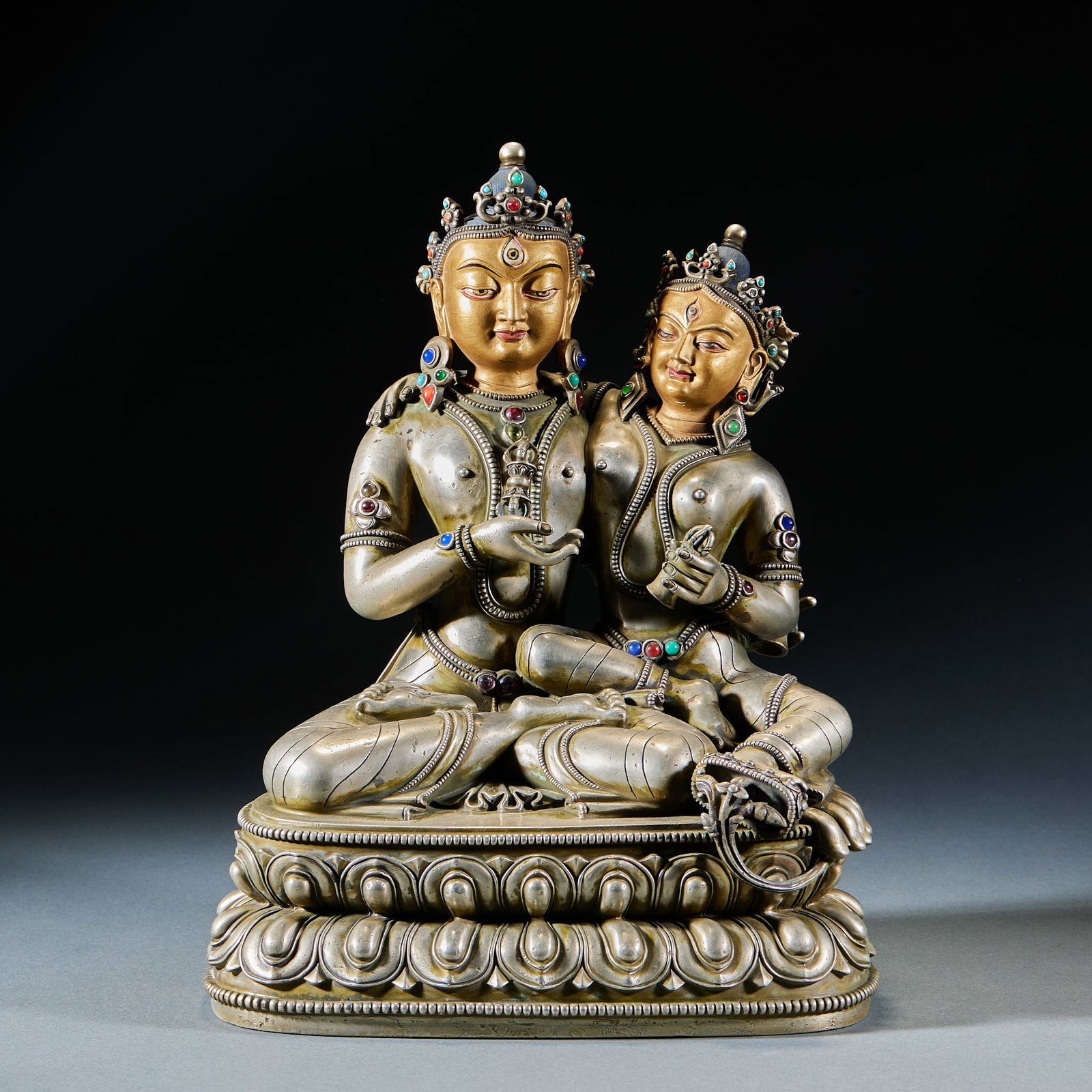 Silver Gem-Inlaid Yab-Yum Buddha: Silver Gem-Inlaid Yab-Yum Buddha: Material is silver. Cast, carved and inlaid with gems to shape Yab-Yum Buddha, solemn face, smooth clothing lines, inlaid with multi-treasure. Size: Height 29cm, Leng