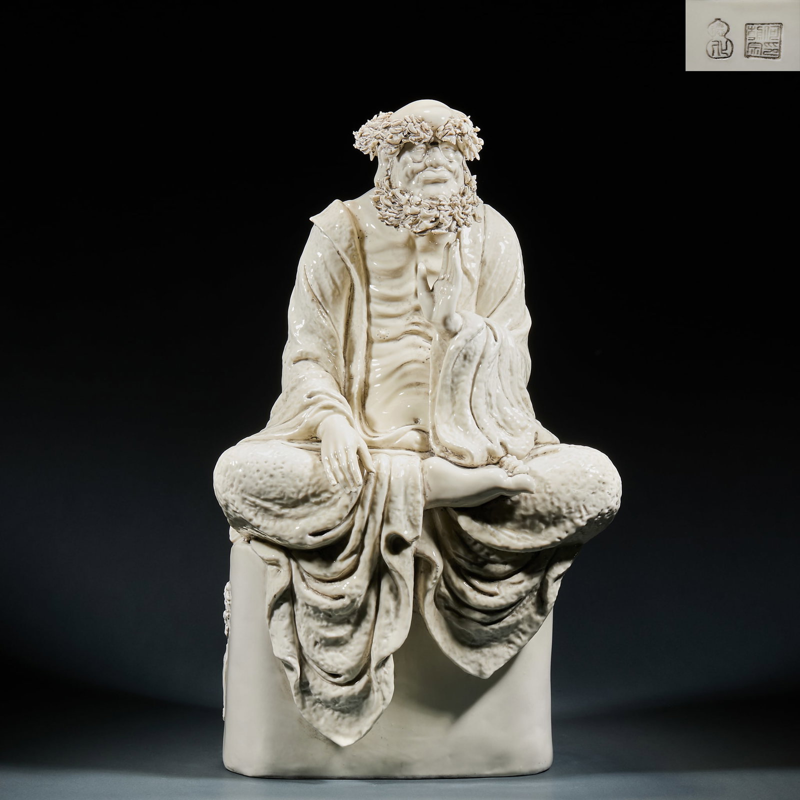 Dehua Kiln He Chaozong Style Dharma Statue: Dehua Kiln He Chaozong Style Dharma Statue: Made of Dehua white porcelain, crafted as a seated Dharma figure with flowing robe lines and vivid facial features, inscribed with "He Chaozong" mark. The