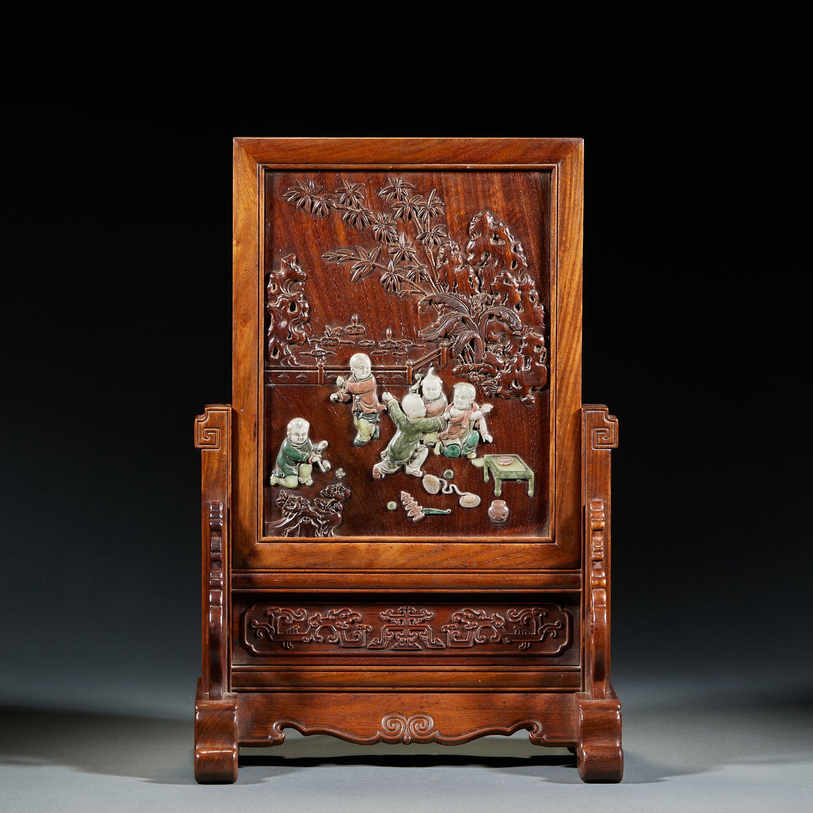Huanghuali Inlaid Screen with Children at Play Pattern: Huanghuali Inlaid Screen with Children at Play Pattern: Huanghuali wood inlaid with porcelain carved children at play motif, base carved with interlocking patterns and exquisite workmanship. Specifica
