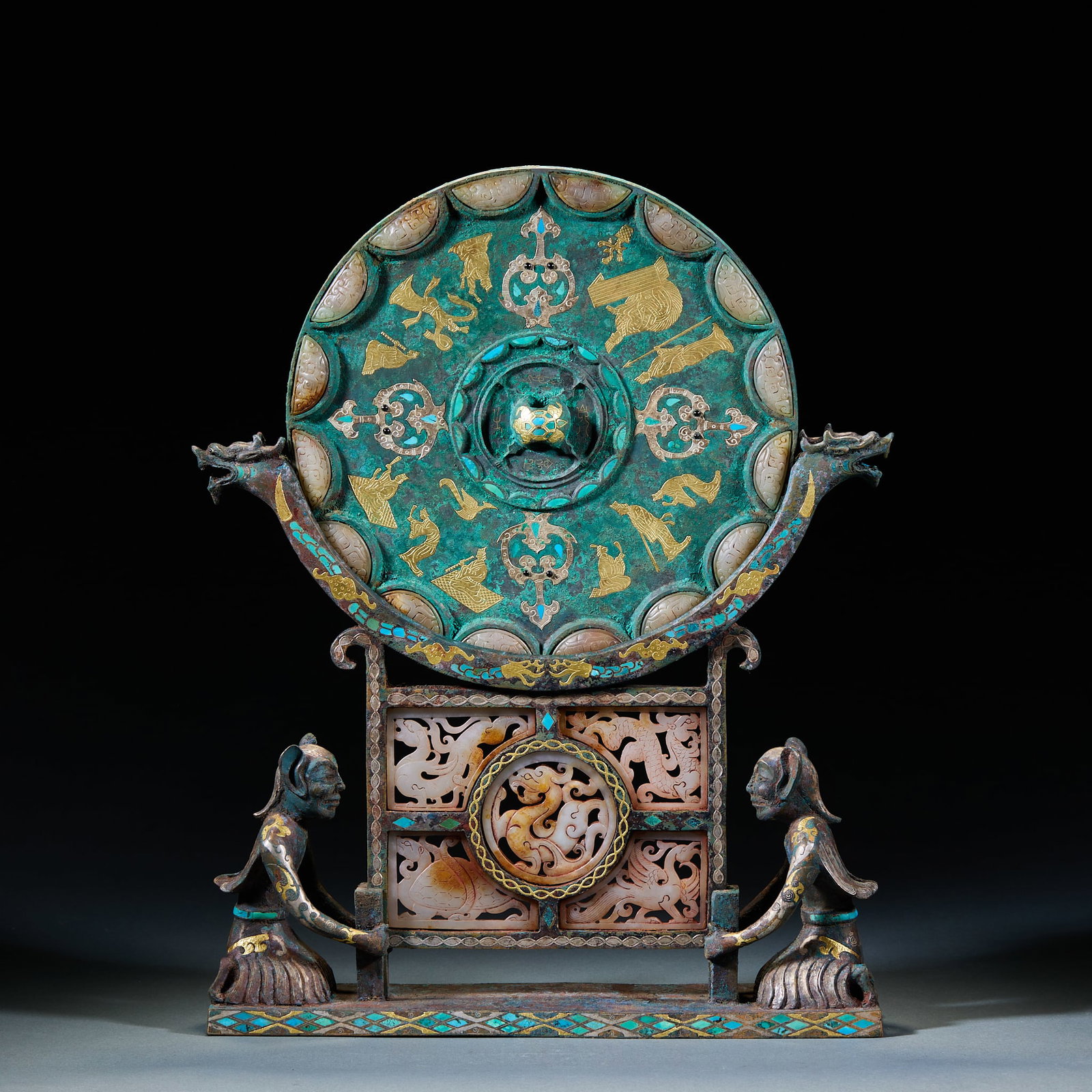 Warring States to Han Period Gold and Silver Inlaid Turquoise and Jade Bronze Mirror with Hu Figure: Warring States to Han Period Gold and Silver Inlaid Turquoise and Jade Bronze Mirror with Hu Figure Base: Bronze vessel adopting gold and silver inlay, turquoise and jade inlay craftsmanship with Hu f