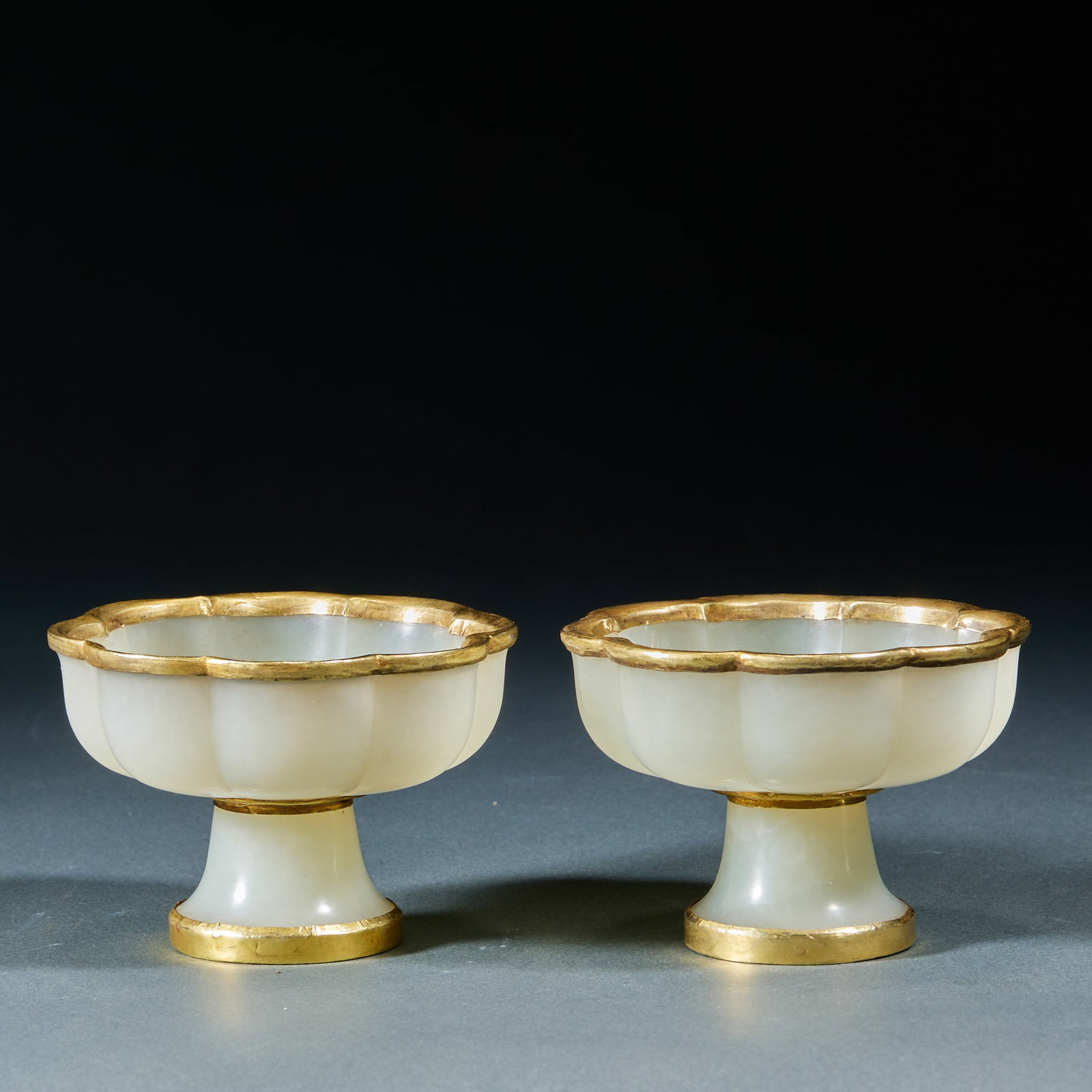 Hetian Jade Gold Wrapped Cup, A Pair: Hetian Jade Gold Wrapped Cup, A Pair: Made of Hetian jade with gold wrapping on the rim and foot, mild jade texture, preserved as a pair. Single piece: height 5.5cm, caliber 8cm; total weight 232g. Cu