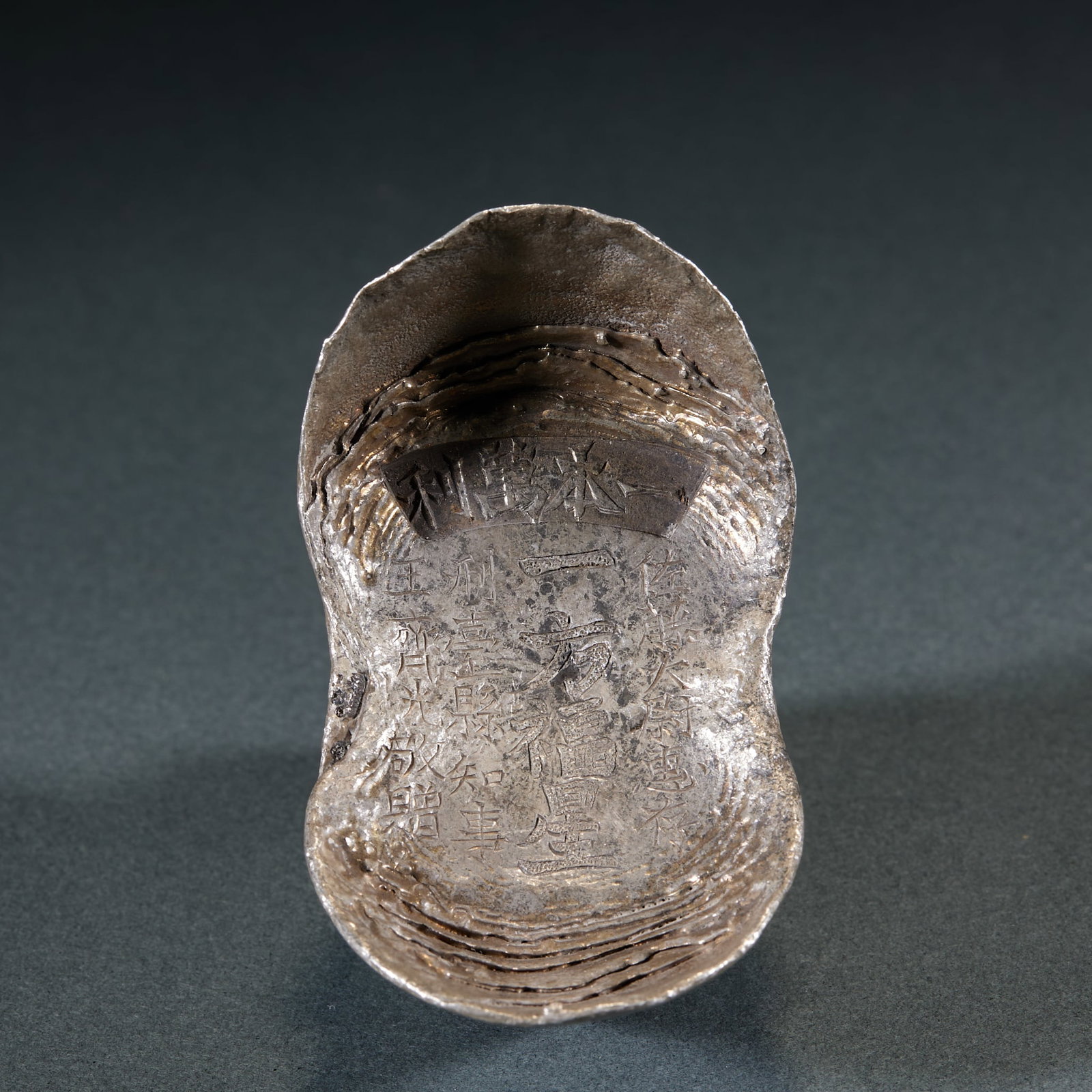 Profit Multiplied Silver Ingot: Profit Multiplied Silver Ingot: Pure silver cast in traditional sycee form, surface chased with auspicious inscriptions such as "Profit Multiplied", clear carving lines, mild patina and pure silver qu