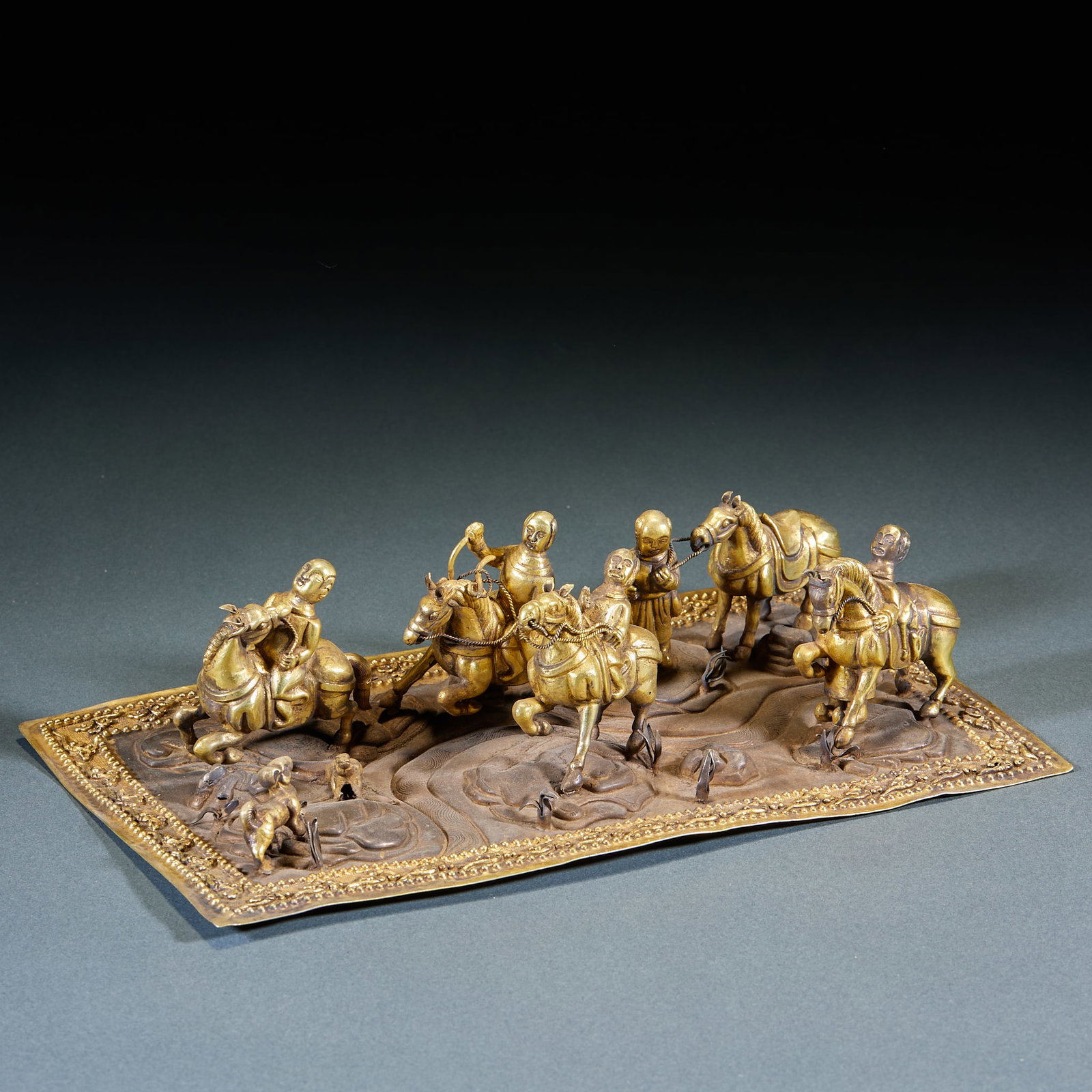 Gilt Silver Hu Hunting Relief Plate: Gilt Silver Hu Hunting Relief Plaque: Silver base fully gilt, crafted in three-dimensional relief with chased Hu hunting scenes of vivid figures, horses and beasts, exquisite chasing work and full