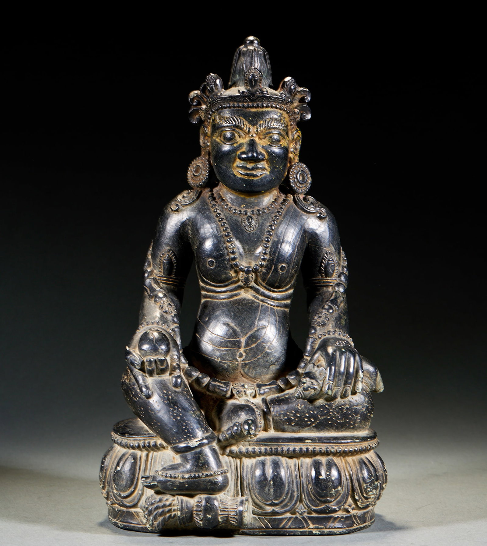 Black Stone Yellow Jambhala: Black Stone Yellow Jambhala Statue: Dense refined black stone material, exquisite carving craft, rigorous Buddhist iconography for Yellow Jambhala, holding ritual artifact with finely carved robe line
