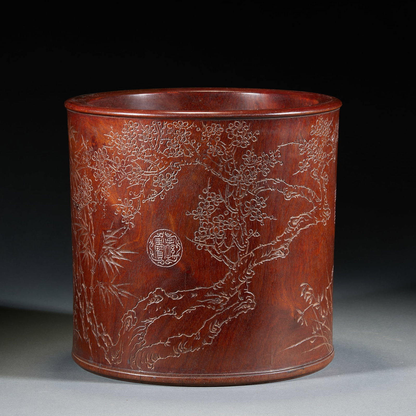 Qing Dynasty Huanghuali Plum Orchid Bamboo Chrysanthemum Brush Pot: Qing Huanghuali Plum Orchid Bamboo Chrysanthemum Brush Pot: Hollowed from single Huanghuali log, body incised with plum, orchid, bamboo and chrysanthemum patterns in smooth neat carving lines, clear