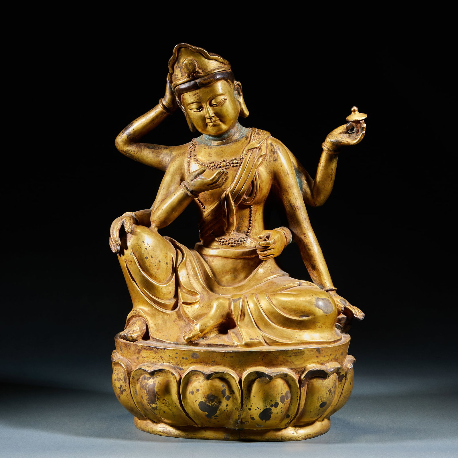 Gilt Bronze Six-Armed Guanyin: Gilt Bronze Six-Armed Guanyin Statue: Solemn iconography with six arms each holding sacred attributes, seated upon a lotus throne. Fully gilded with masterful detailing and compassionate facial expres