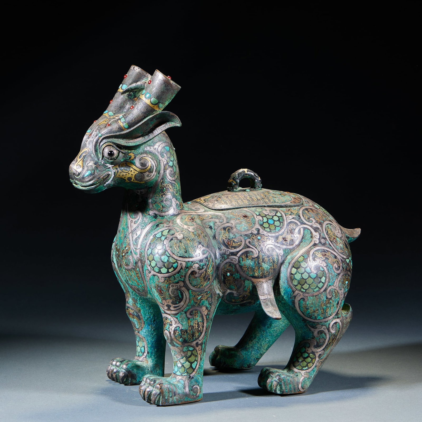Warring States to Han Period Gold and Silver Inlaid Turquoise Inscribed Bronze Auspicious Beast: Warring States–Han Gold-Silver Inlaid Turquoise Inscribed Bronze Auspicious Beast: Bronze body fully inlaid with gold, silver and turquoise, bearing ancient inscriptions. Vivid auspicious beast