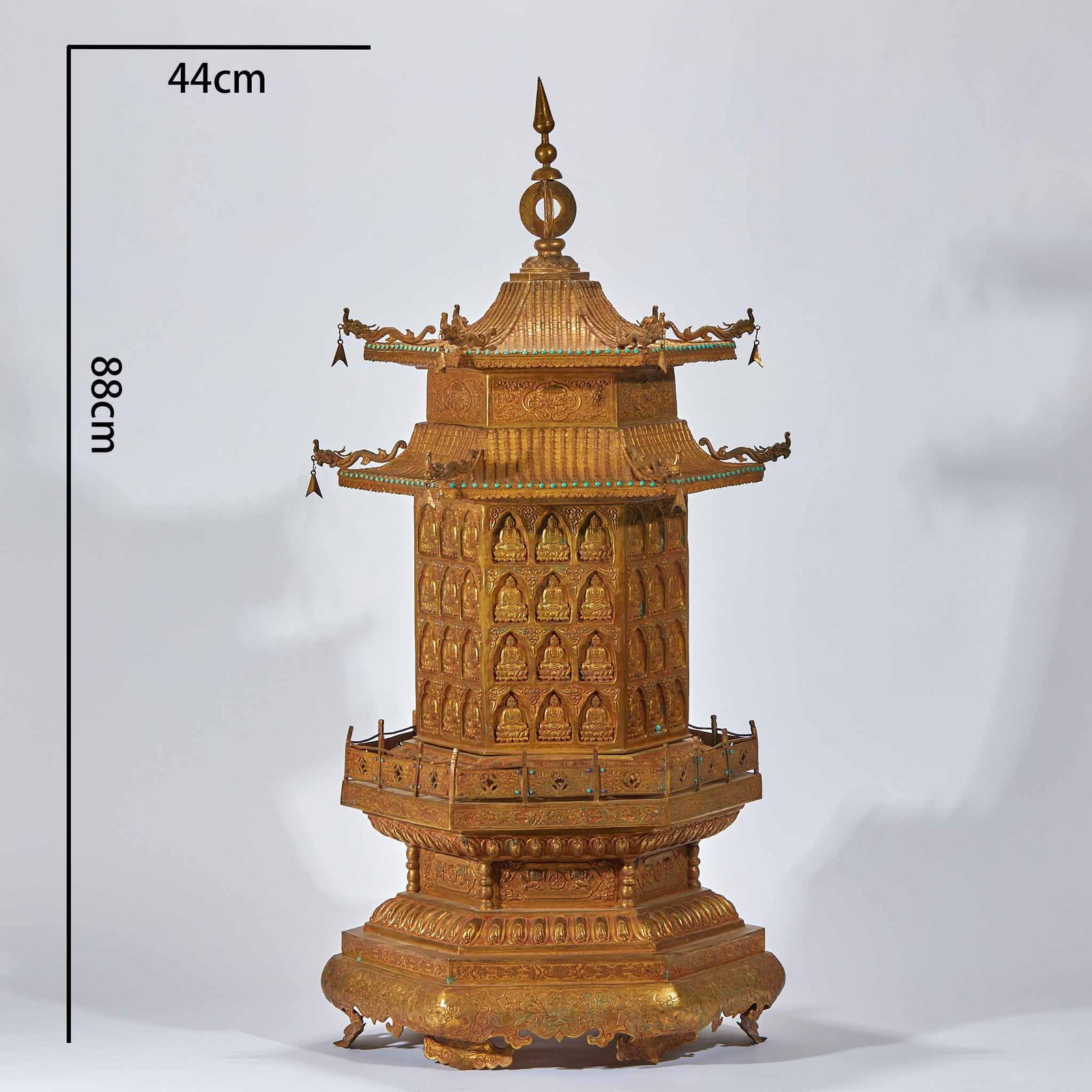 Gilt Bronze Ten Thousand Buddhas Paying Homage Pagoda: Gilt Bronze Ten Thousand Buddha Pilgrimage Pagoda: Fully gilt bronze pagoda densely carved with Buddha statues all over the body, solemn grand form adorned with turquoise inlay accents. Height 88cm, d