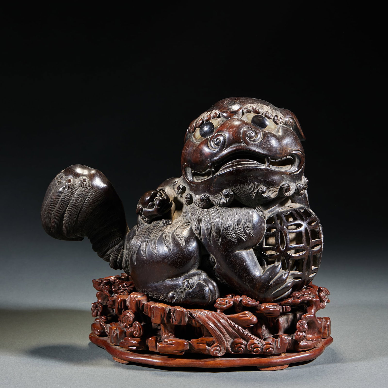 Red Sandalwood Grand Tutor and Junior Tutor Ornament: Red Sandalwood Grand Master and Junior Lion Ornament: Carved from single natural red sandalwood log via round and openwork carving techniques, depicting lion playing ball and cub lion motifs.