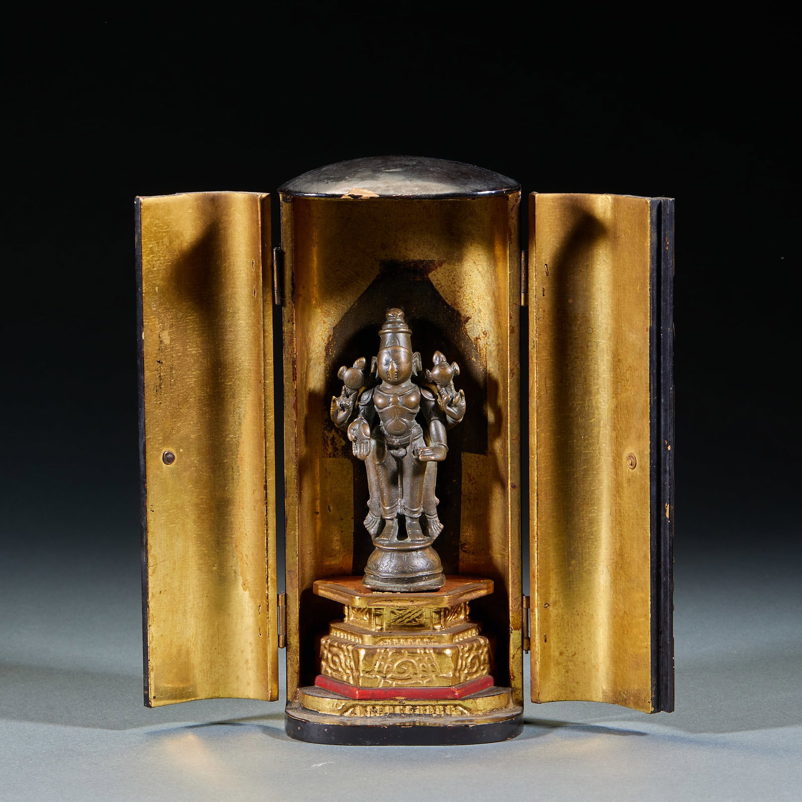 Bronze Vishnu Standing Statue with Niche: Bronze Vishnu Standing Statue (With Niche): Bronze cast with neat solemn iconography and concise condensed lines, preserved complete with lacquered gold niche. Statue height 9.5cm, length 4.8cm,