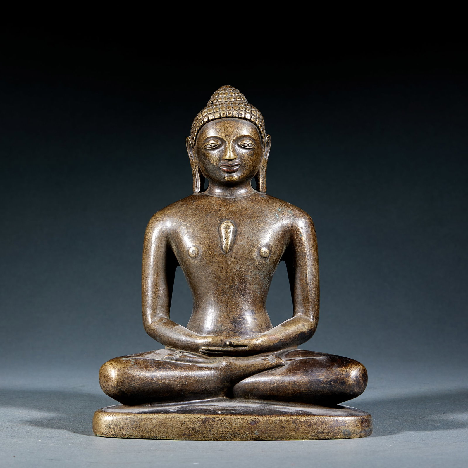 Alloy Copper Jainism Founder Statue: Alloy Copper Jain Tirthankara Statue: Alloy copper cast with primitive archaic style, concise condensed lines and simple robe details embodying traditional Jain sculptural features. Height 27cm,