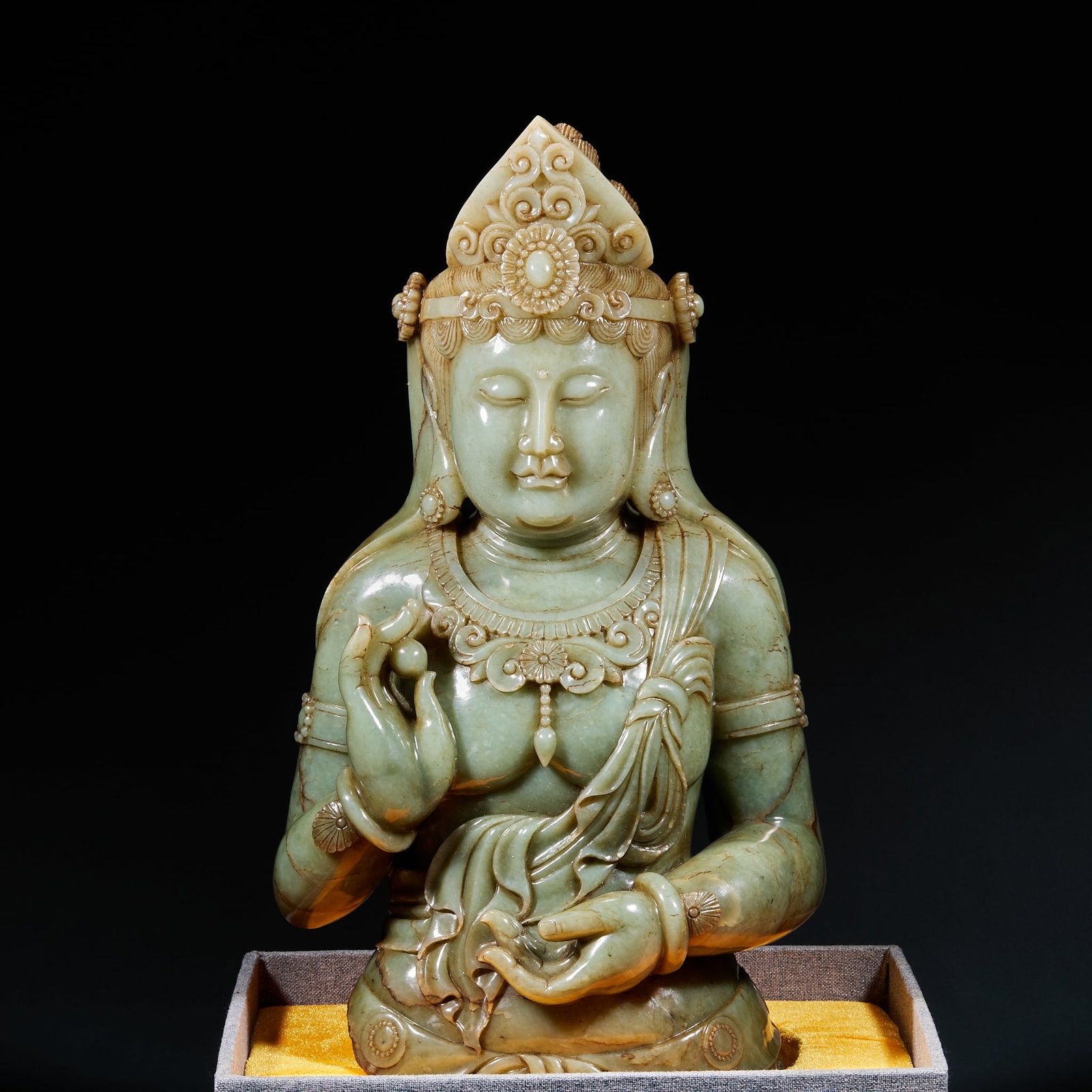 Hetian Jade Half-Body Guanyin Statue: Hetian Jade Guanyin Half-Body Statue: Fine mild Hetian jade fully carved into half-body Guanyin with dignified serene facial features, intricate headdress and jewel details, smooth natural robe