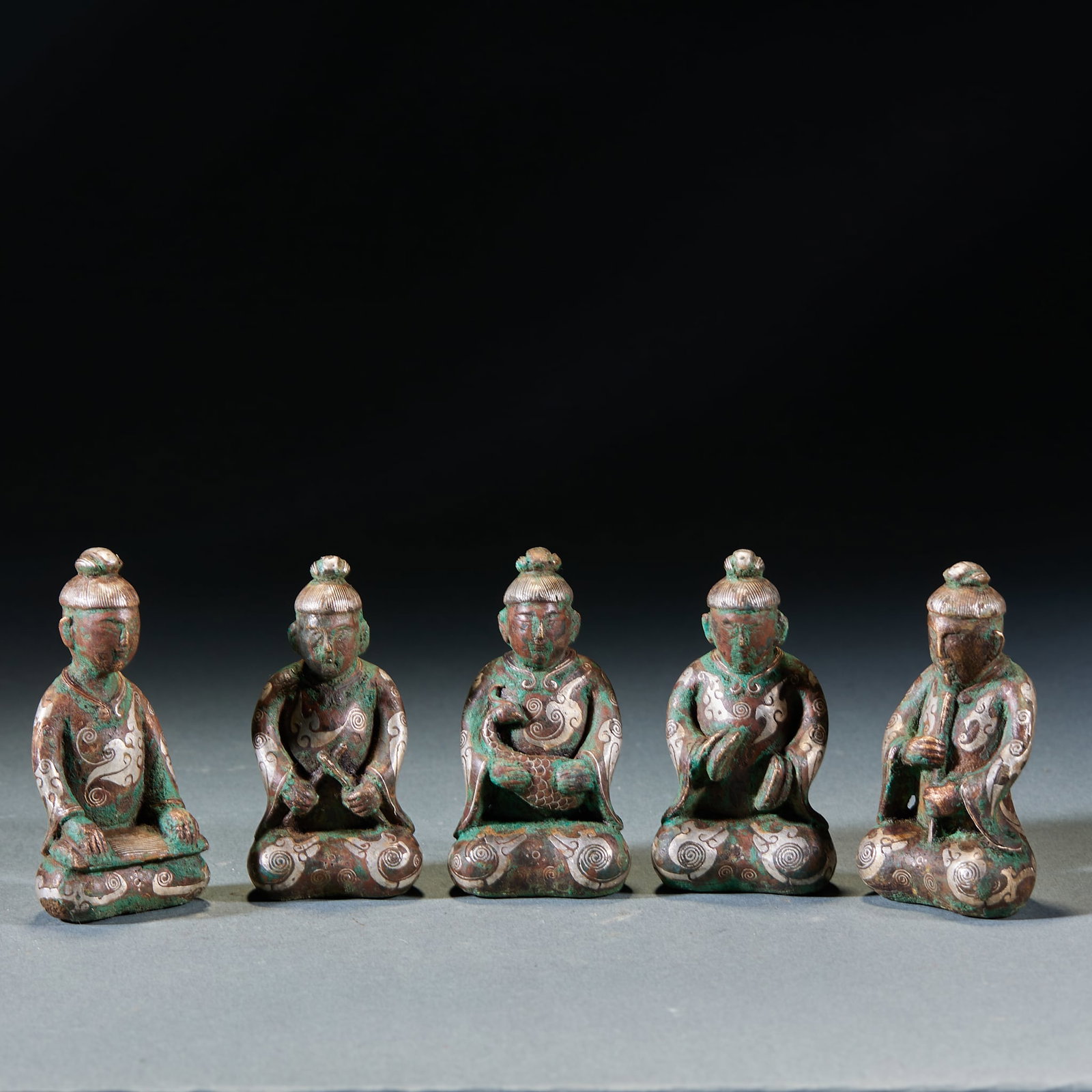 Bronze Silver Inlaid Five Musician Figurines: Silver-Inlaid Bronze Five Musician Figurines: Bronze silver-inlaid set of five seated musician figures holding different musical instruments, robe and decorative patterns depicted via fine silver