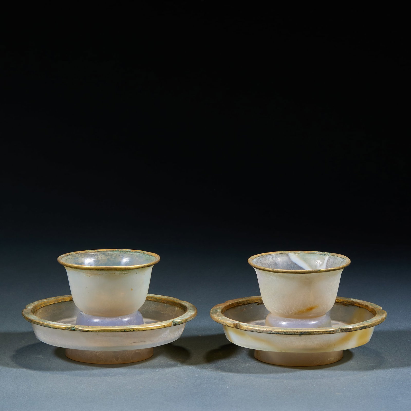 Agate Gold Wrapped Teacups, A Pair: Agate Gold-Inlaid Tea Cup Pair: Natural agate with gold inlaid rim and base, translucent agate texture with natural grain, fine delicate gold ornament craft. Height 7cm, diameter 12cm. Ancient noble t