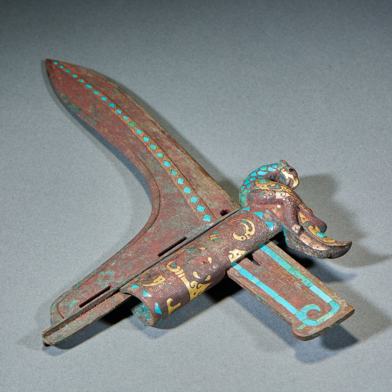 Warring States to Han Period Gold and Silver Inlaid Turquoise Bronze Ge Dagger-Axe: Warring States–Han Gold-Silver Turquoise Inlaid Bronze Ge Dagger-Axe: Bronze body fully decorated with gold-silver inlay and turquoise embellishment, exquisite decorative patterns and well-preserved