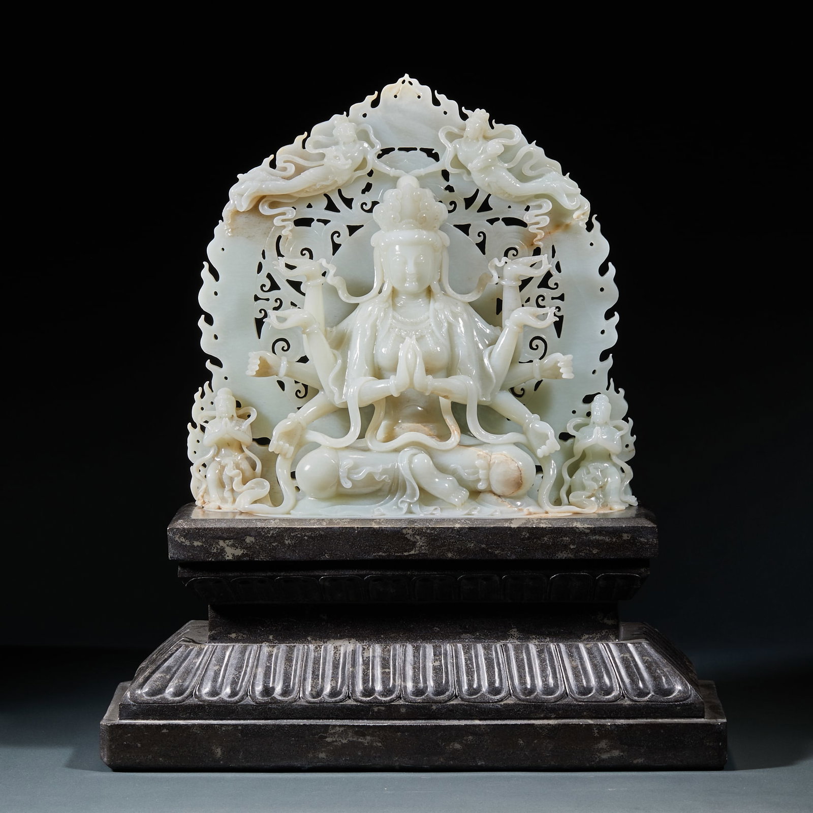 Hetian Jade Multi-Armed Seated Guanyin with Jasper Base: Hetian Jade Multi-Armed Guanyin Seated Statue with Jasper Base: Hetian jade carved multi-armed Guanyin with solemn Dharma appearance and exquisite craftsmanship, matched with jasper lotus throne base,
