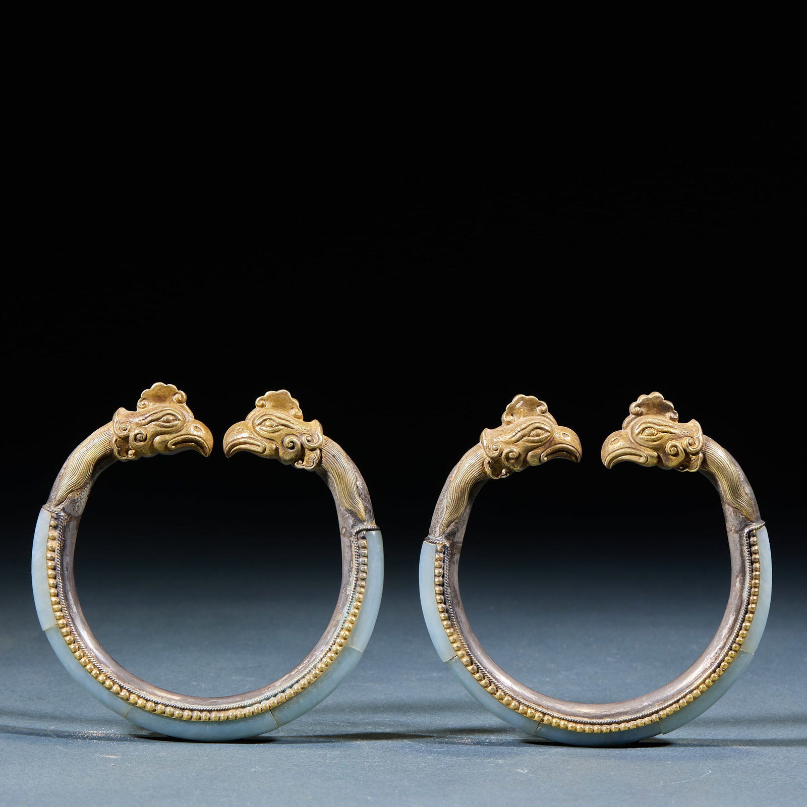Gilt Silver Hetian Jade Wrapped Phoenix Head Bangle Inlaid Agate Beads: Silver-Gilt Hetian Jade Agate-Inlaid Phoenix Head Bracelet: Silver-gilt wrapped Hetian jade bracelet carved with phoenix head ornament at the terminal, embedded with agate beads, exquisite delicate cr