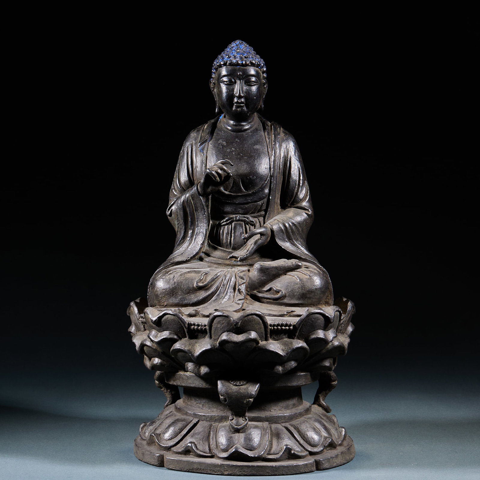 Bronze Seated Sakyamuni Statue: Copper Sakyamuni Seated Statue: Copper cast Buddha sitting in cross-legged posture, smooth flowing robe lines and solemn dignified demeanor. Height 31cm, length 17.5cm, width 15.5cm. Ancient copper Bu