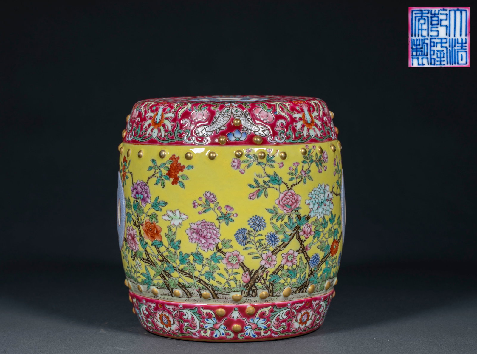 Qianlong Mark Famille Rose Flower Pattern Stool: Qianlong Mark Famille Rose Flower Pattern Stool: Porcelain imitating traditional stool shape, yellow glaze ground painted with famille rose flower patterns, stud decorative edge, base marked "Made in
