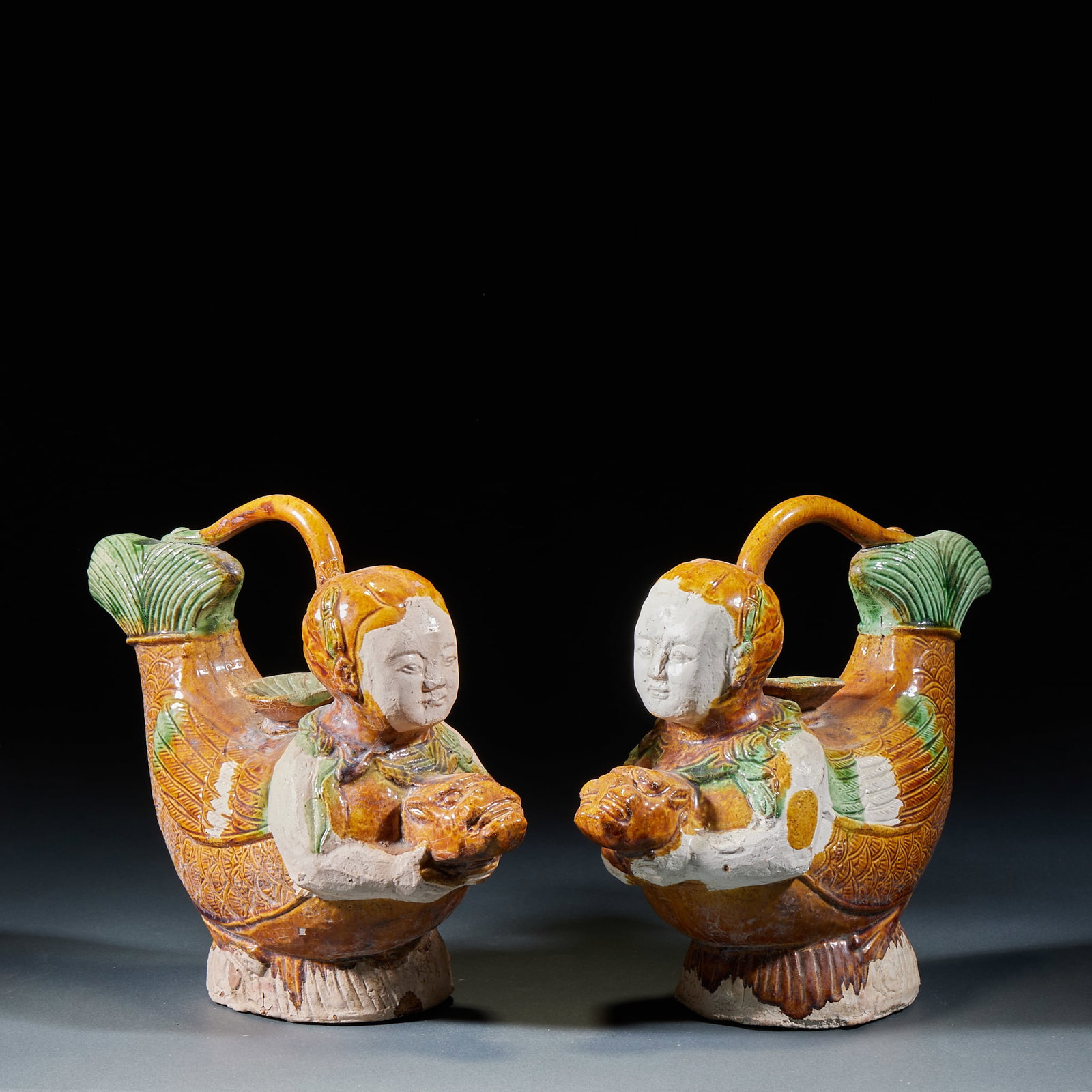 Sancai Human Head Mandarin Duck Pot: Tri-Color Human-Head Mandarin Duck Pot: Ceramic with tri-color glaze coating, unique human-head mandarin duck vessel form, primitive archaic glaze tone and distinctive craft. Height 19cm, length 22.5c