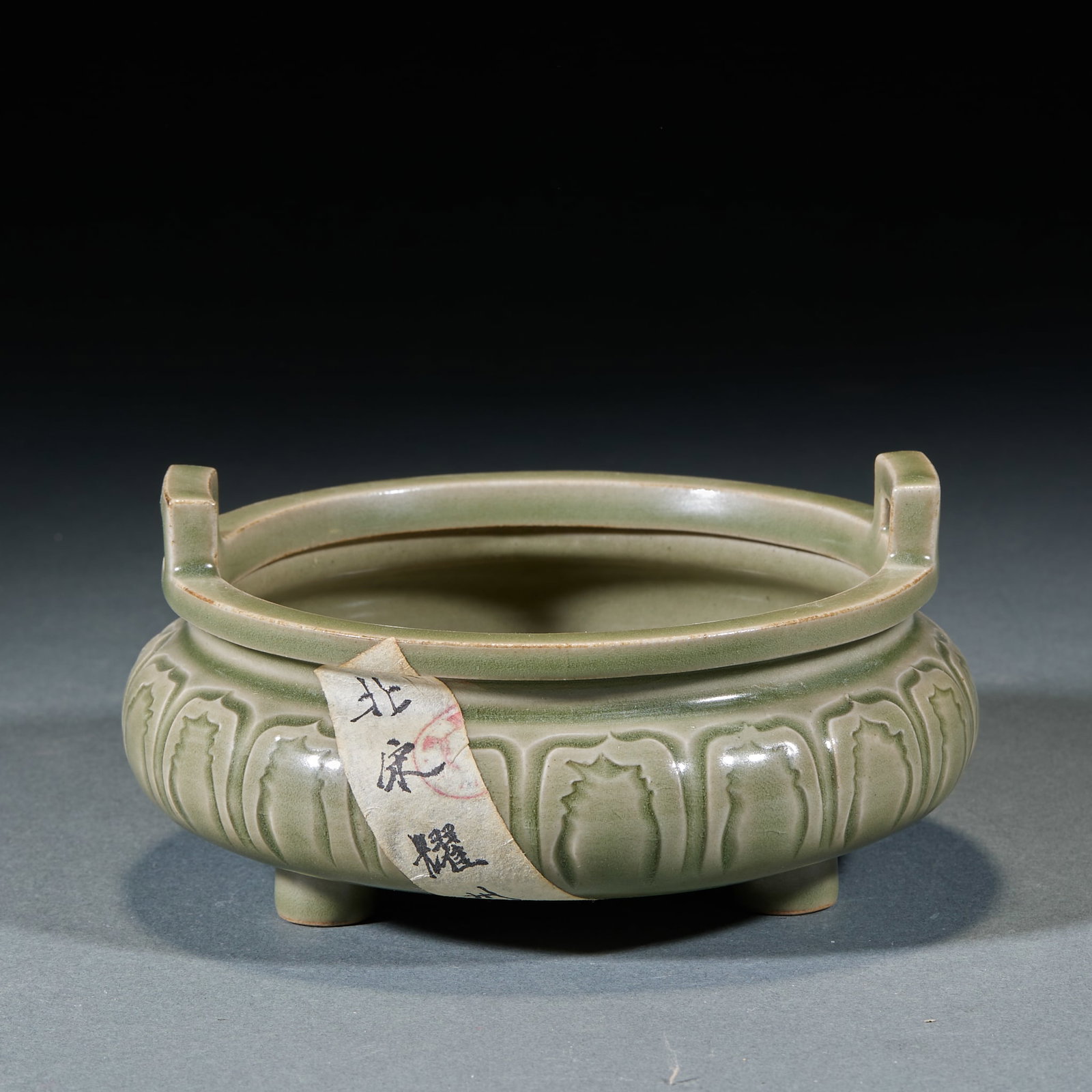 Northern Song Yaozhou Kiln Incense Burner: Northern Song Yaozhou Kiln Incense Burner: Celadon glaze carved with lotus petal patterns, double ears and three feet design, smooth lustrous glaze. Height 7.5cm, diameter 14cm. Elegant Northern Song 