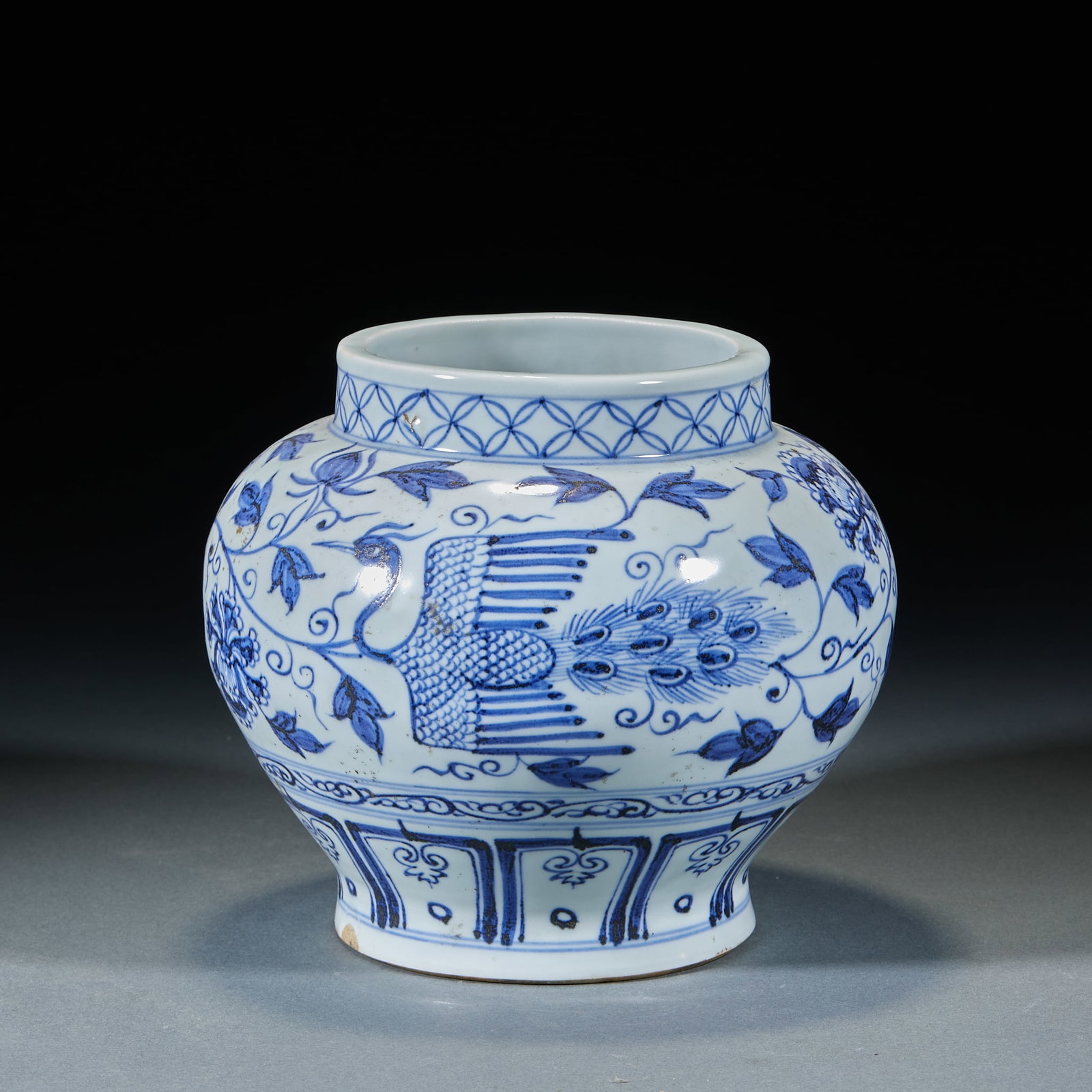 Yuan Dynasty Phoenix Pattern Jar: Yuan Phoenix Pattern Jar: Porcelain painted with blue and white phoenix patterns, round full jar shape and mild lustrous glaze. Height 17cm, diameter 20cm. Daily display ware of Yuan blue and white po