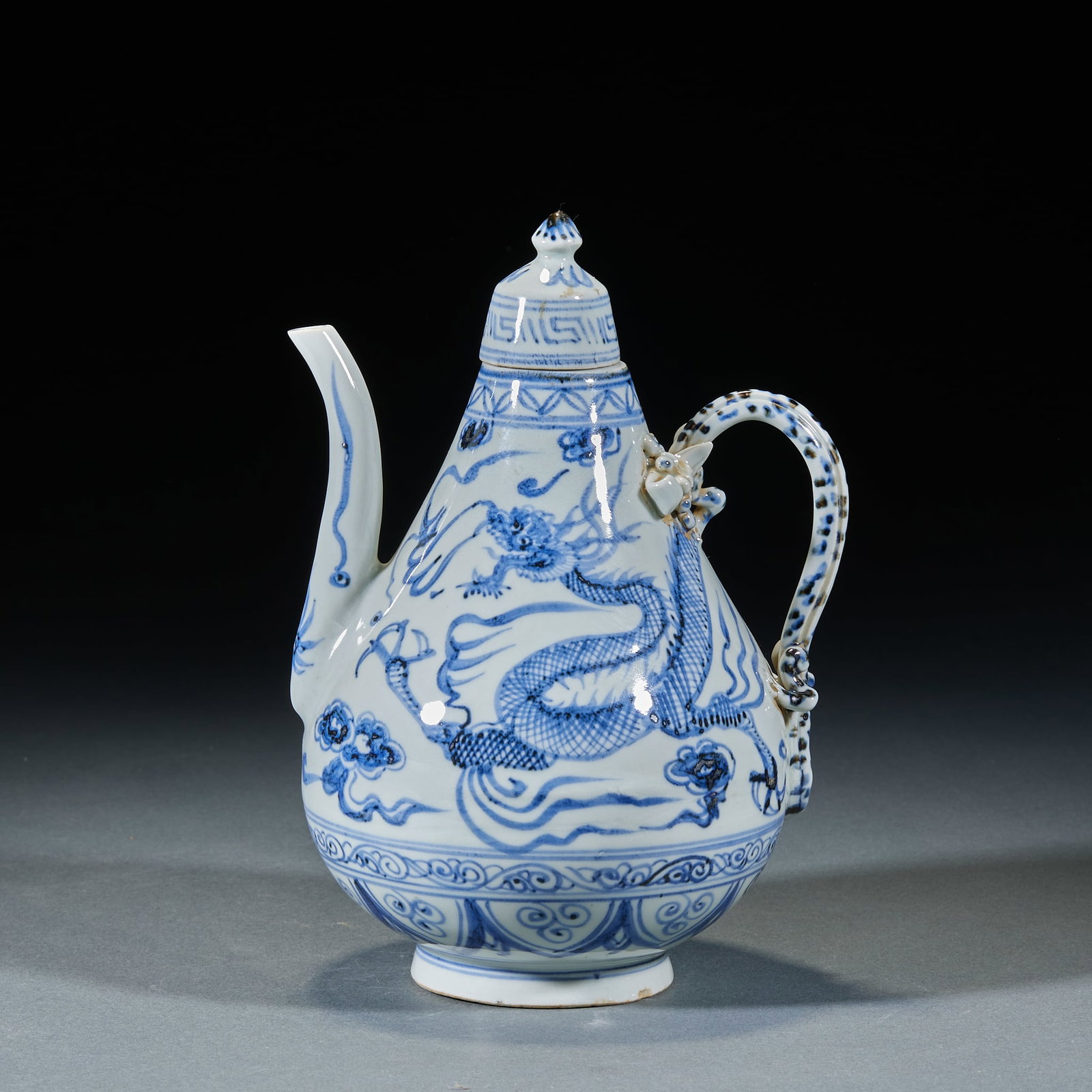 Yuan Dynasty Dragon Pattern Ewer: Yuan Blue and White Dragon Pattern Ewer: Porcelain painted with powerful vivid dragon patterns, lidded ewer design. Height 22.5cm, length 14.5cm, width 13cm. Classic Yuan blue and white vessel with ri