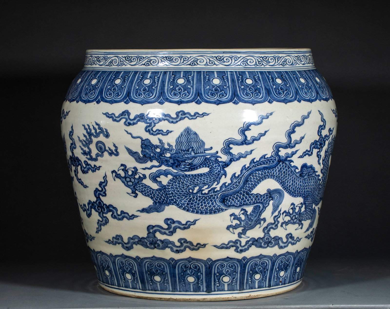 Ming Dynasty Blue and White Dragon Pattern Scroll Hanging Ornament: Ming Blue and White Cloud Dragon Pattern Large Cylindrical Ornament: Porcelain body fully covered with white glaze, decorated with blue and white scroll grass patterns, lotus petal patterns and vigoro