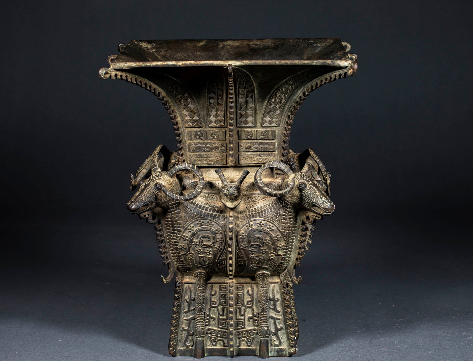 Pre-Ming Four Sheep Square Zun: Pre-Ming Four Sheep Square Zun: Cast in bronze via separate casting and relief craft, decorated with four sheep heads, cloud thunder patterns and taotie patterns all over the body with complicated orn