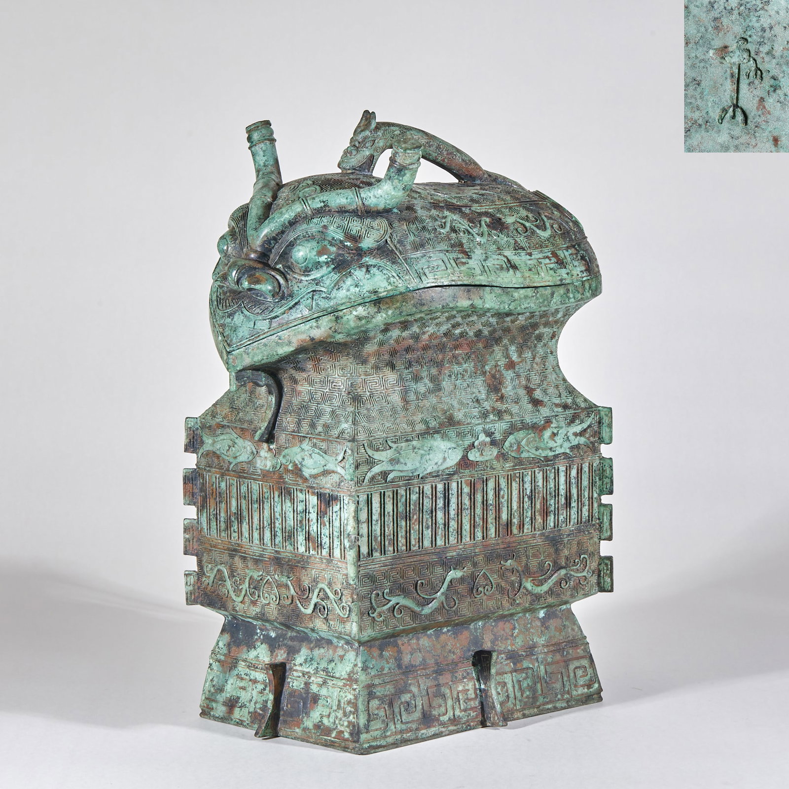 Western Zhou Beast Head Square Yi: Western Zhou Beast Head Square Yi: Cast in bronze with relief and line carving techniques, decorated with beast face patterns and cloud thunder patterns, the square Yi features dignified shape and sol