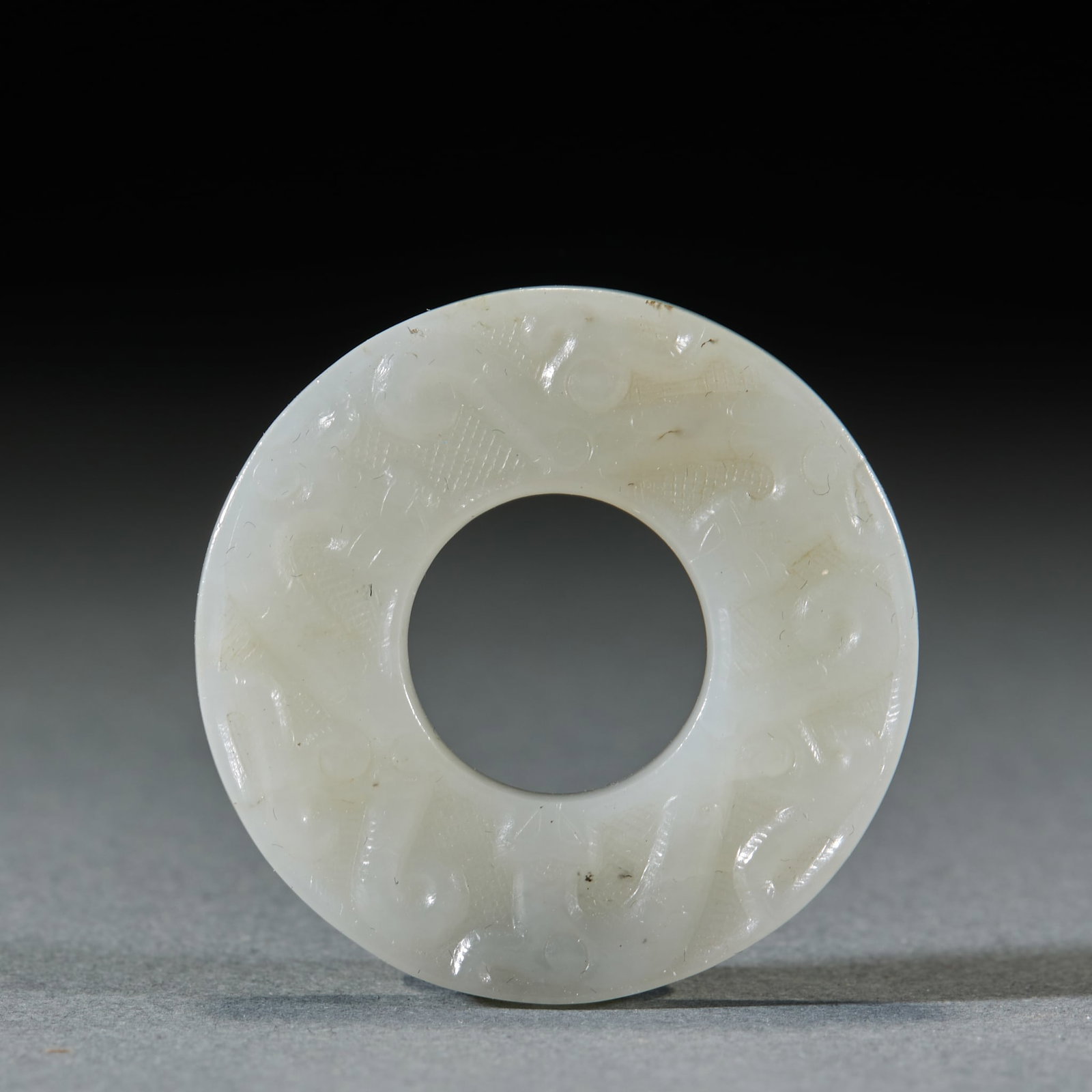Chilong Pattern Jade Bi Disc: Chilong Pattern Jade Bi: Made of Hetian jade with shallow carved chilong patterns, mild and delicate texture; Thickness 0.5cm, diameter 4cm; An ancient jade bi ornament with fluent decorative lines, s