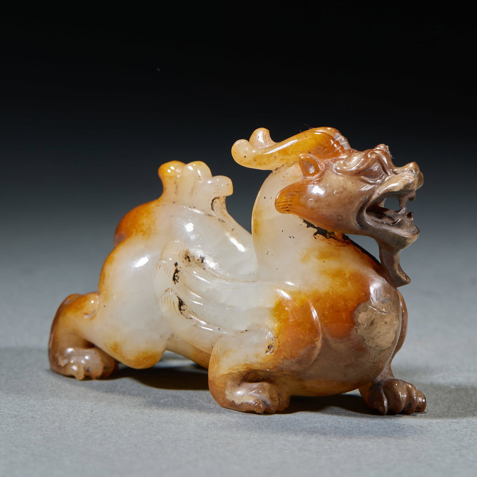 Ancient Jade Chilong Beast: High Ancient Jade Chilong Tiger: Made of Hetian jade with red natural mottling, carved in reclining chilong tiger shape with fluent lines; Height 5.5cm, length 8cm, width 3.5cm, weight 151g; A