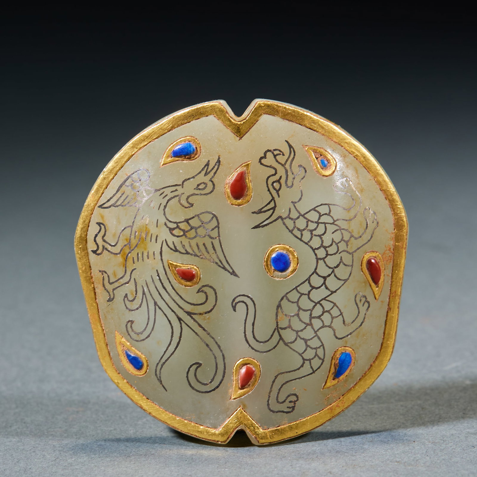 Gold Inlaid Jade Ornament: Gold-Inlaid Jade Ornament: Made of Hetian jade inlaid with gold and gemstones, carved with dragon and phoenix patterns adopting luxurious craft; Length 5.5cm, width 5.5cm, weight 56g; A noble ancient 