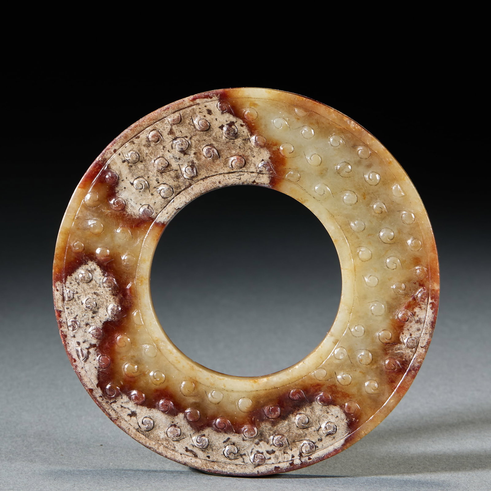 Hetian Jade Grain Pattern Jade Ring: Hetian Jade Grain Pattern Jade Ring: Made of Hetian jade with natural mottling, surface relief carved with grain patterns and regular shape; Diameter 10cm, weight 93g; An ancient ritual vessel with